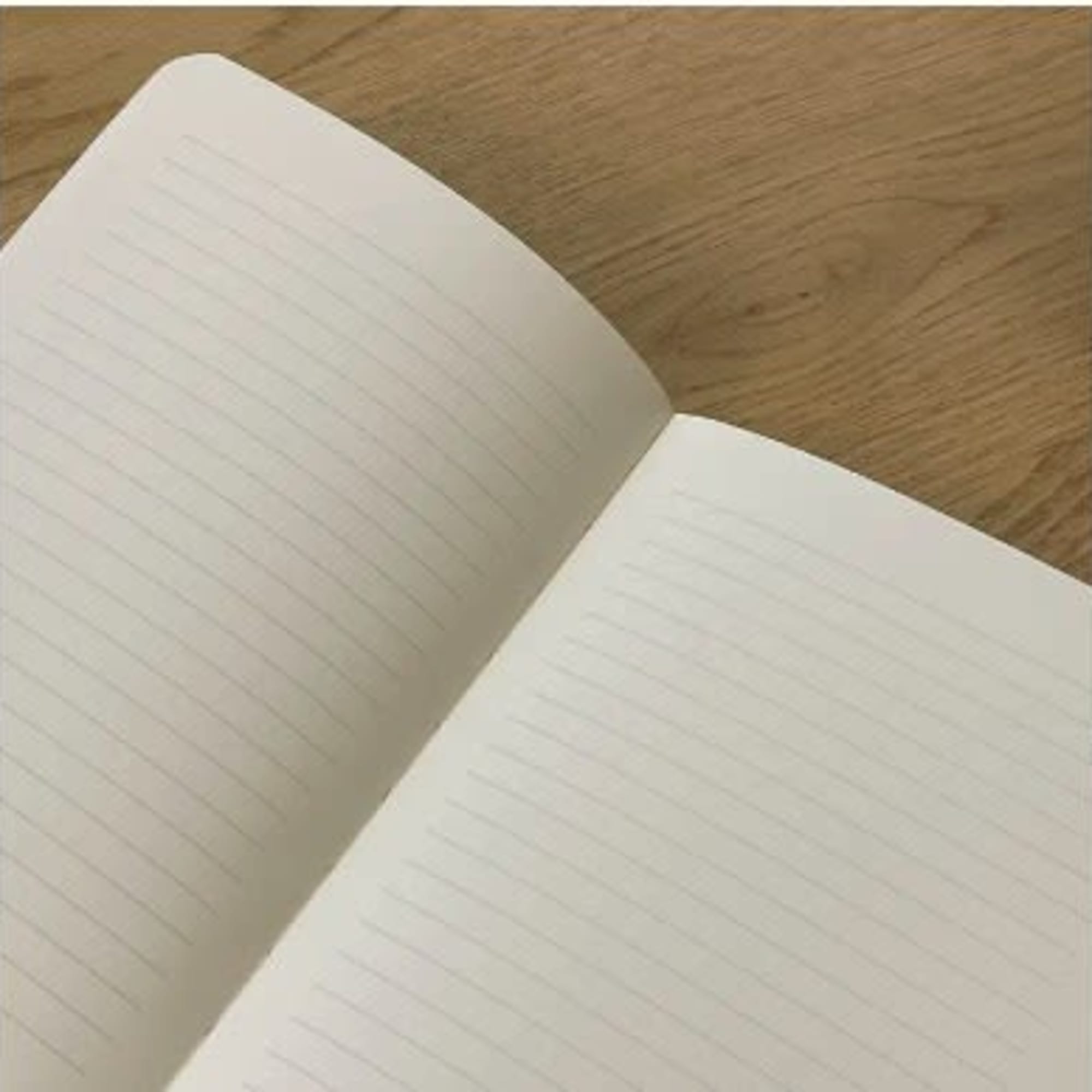 Open lined notebook on a wooden surface