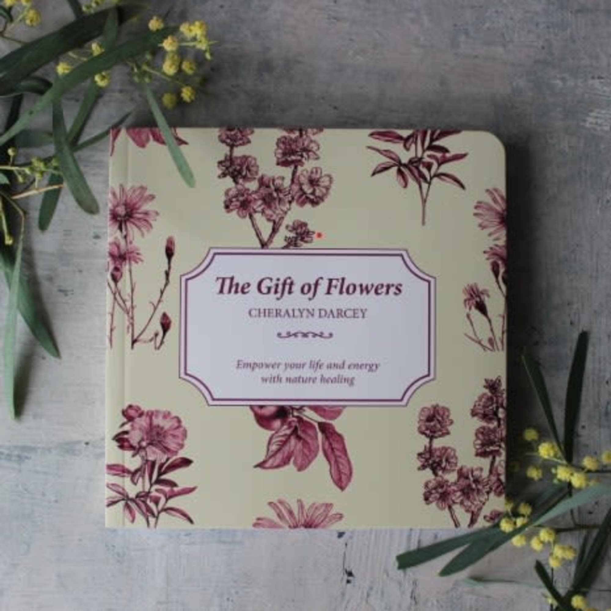 Floral-patterned book titled "The Gift of Flowers" on a gray surface