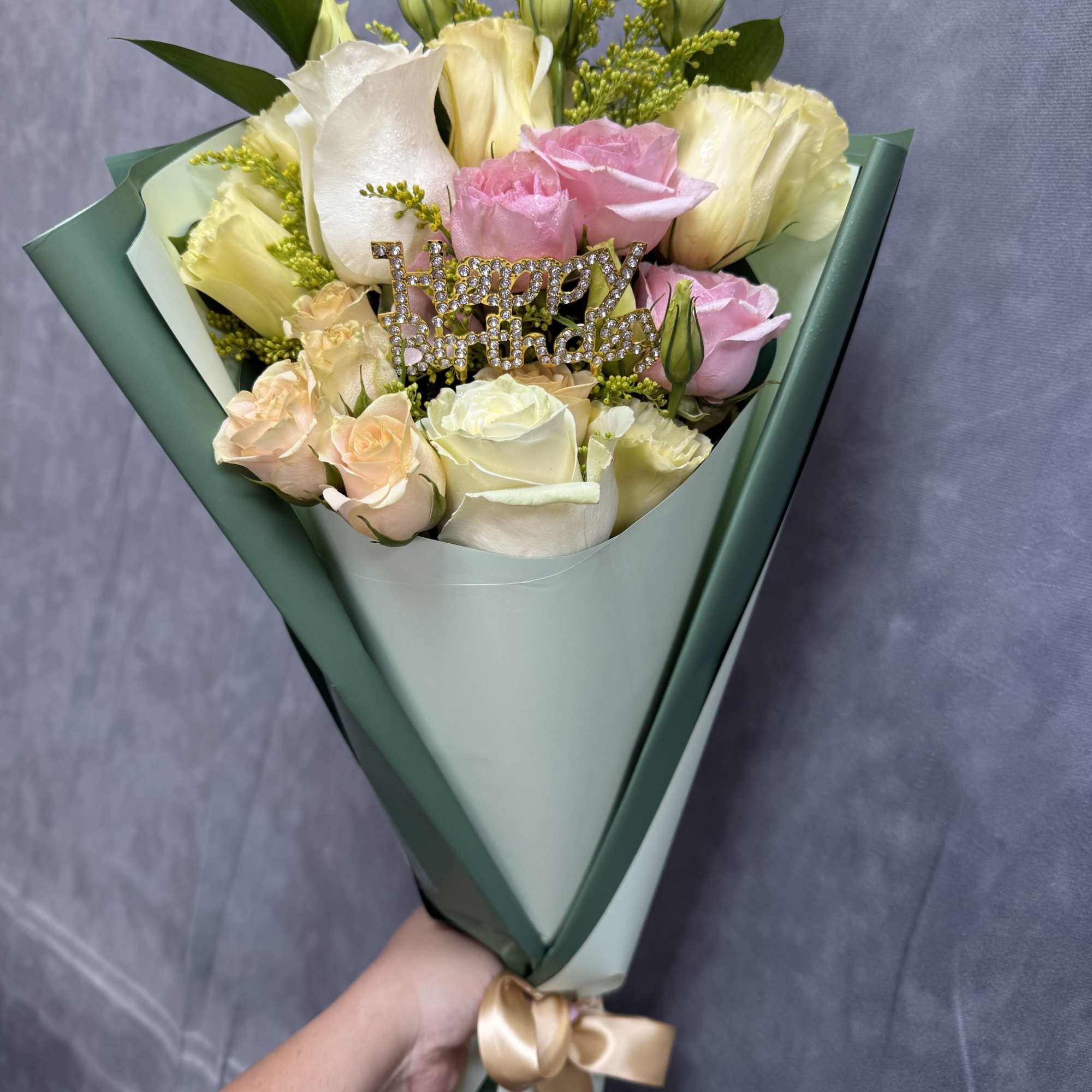 Bouquet of pink and white roses with a birthday topper