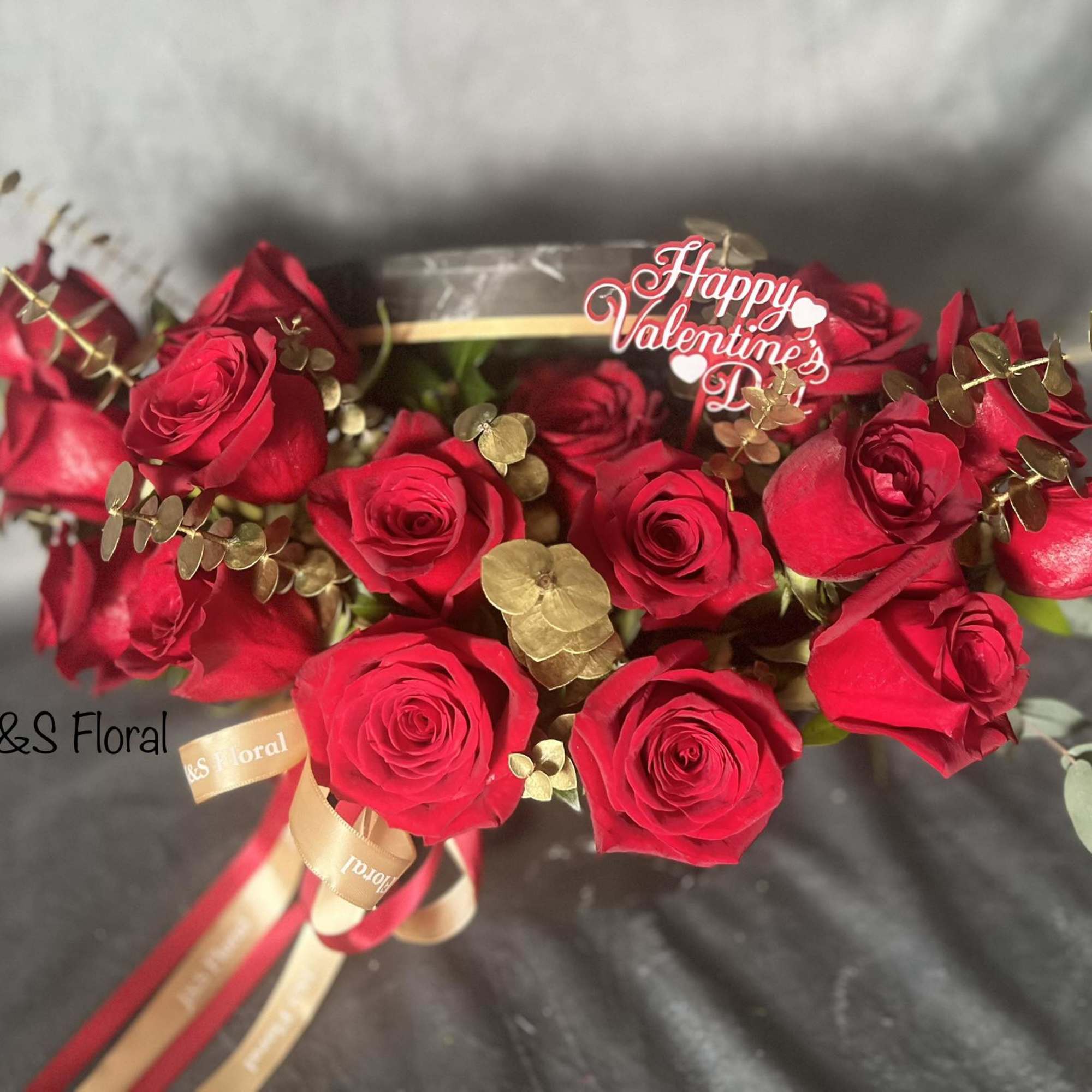 Bouquet of red roses with gold accents and a Happy Valentine's Day topper