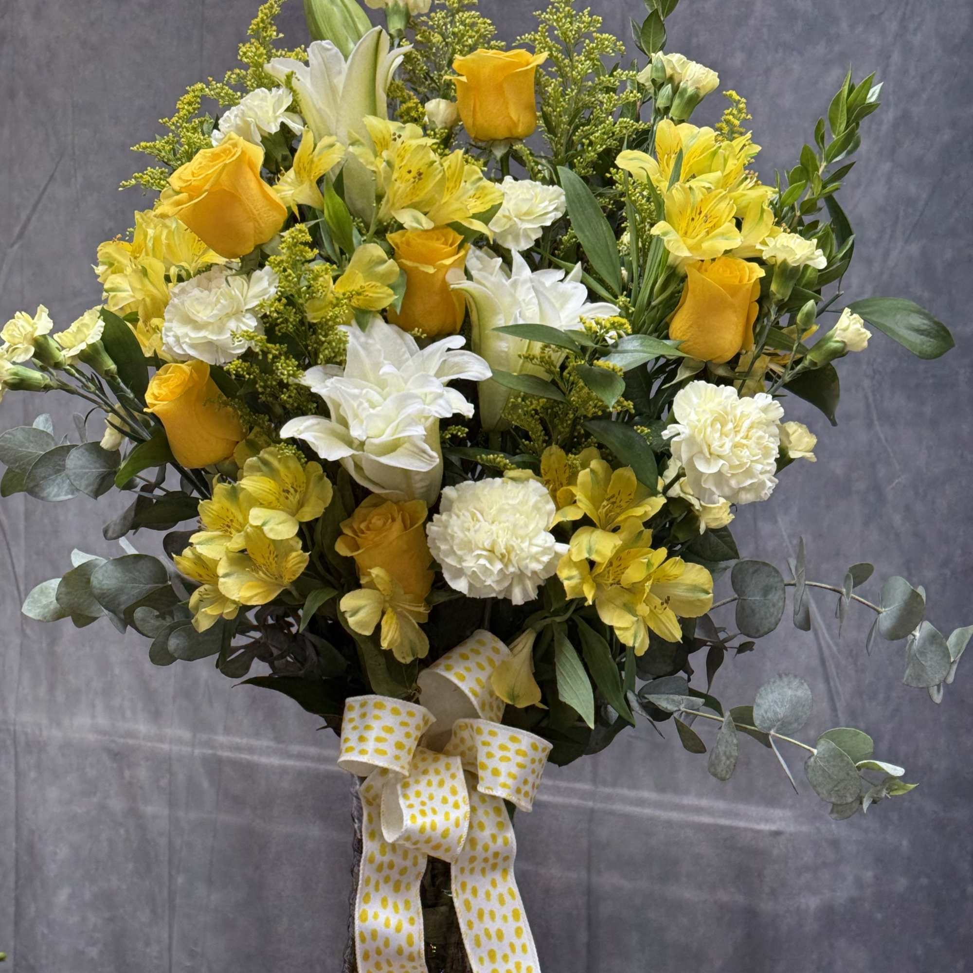 A refreshing blend of vibrant yellow roses and spray roses , yellow