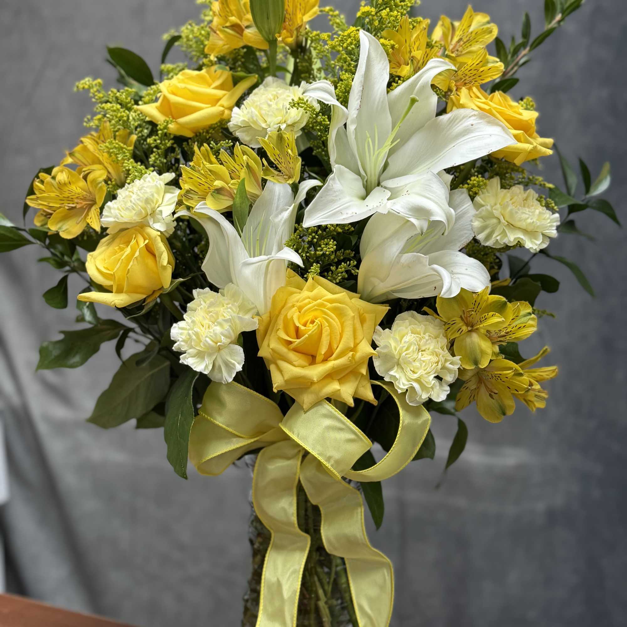 A refreshing blend of vibrant yellow roses and spray roses , yellow