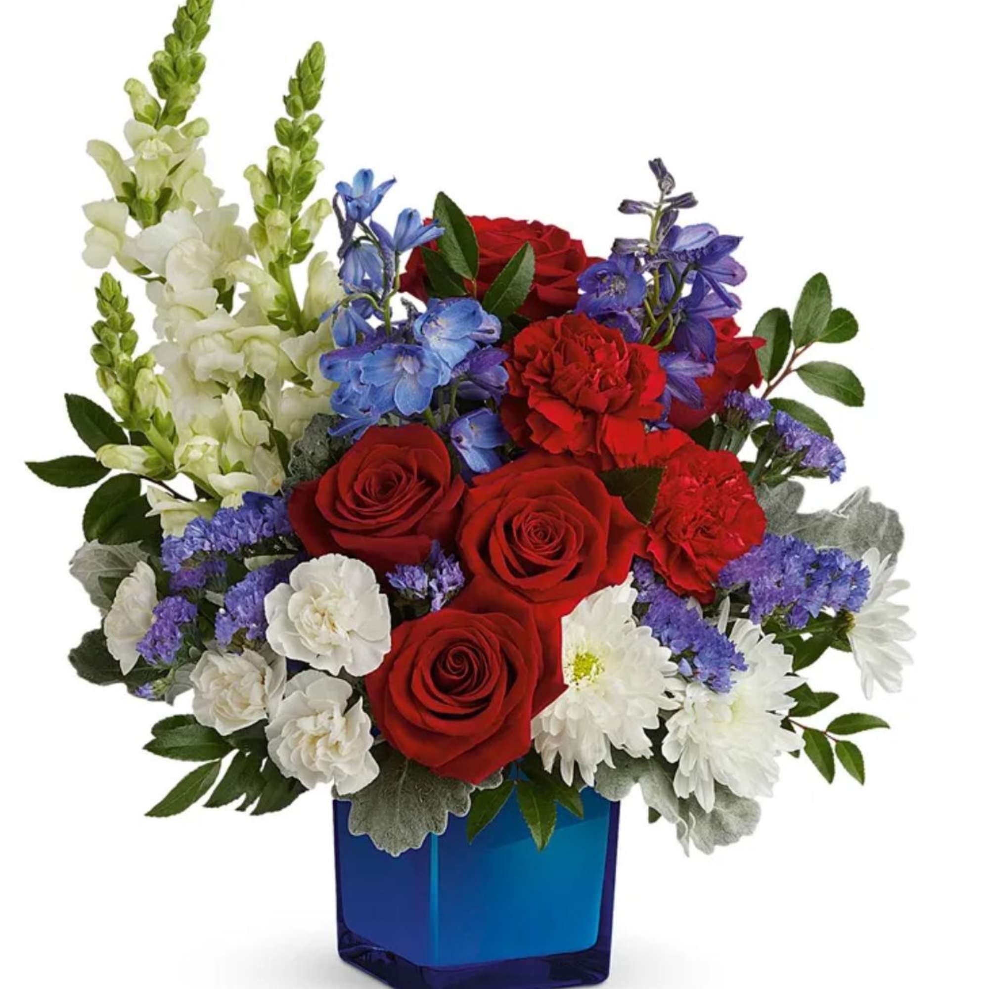 Red roses, white daisies, and blue flowers in a blue glass vase