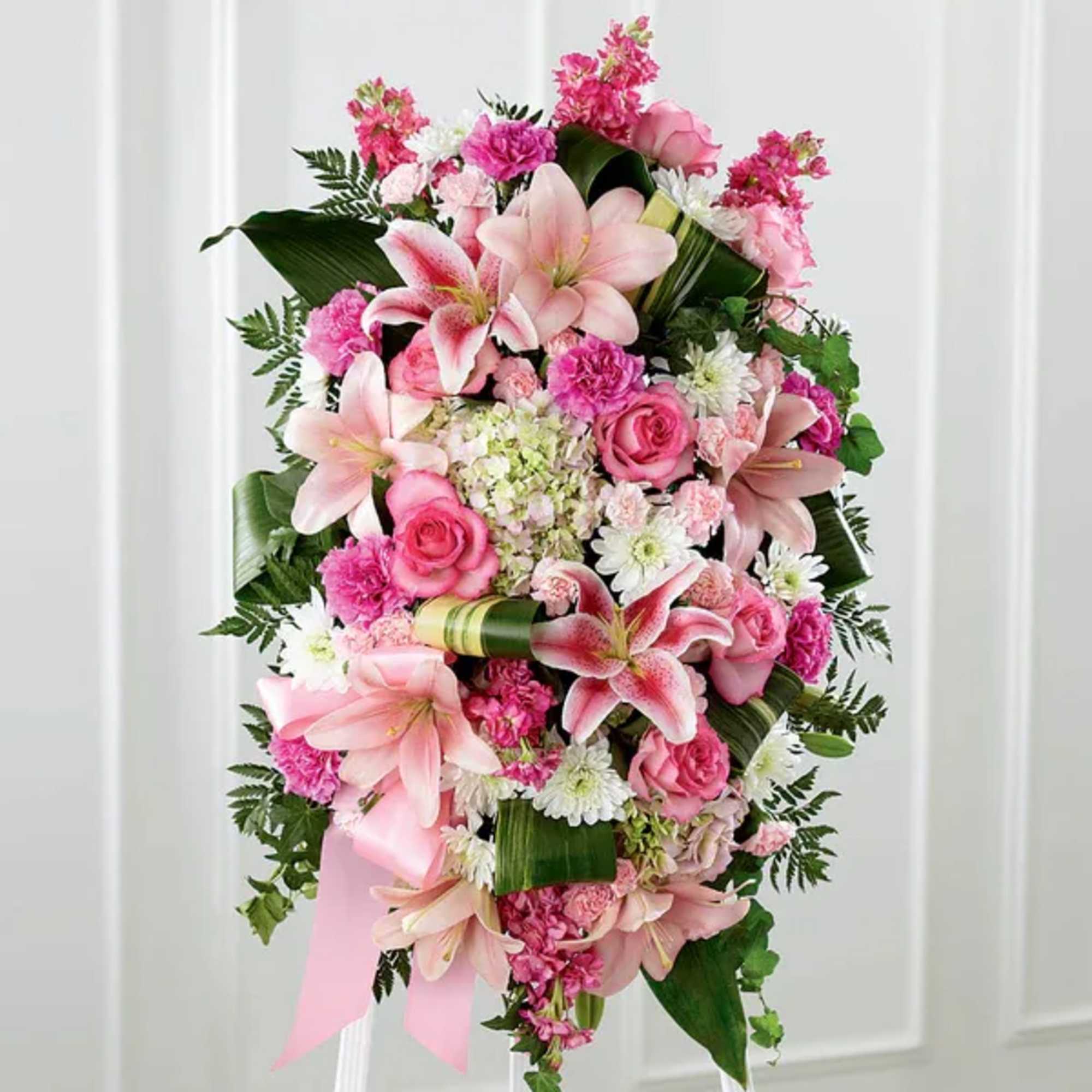 Pink and white floral standing spray with lilies and roses