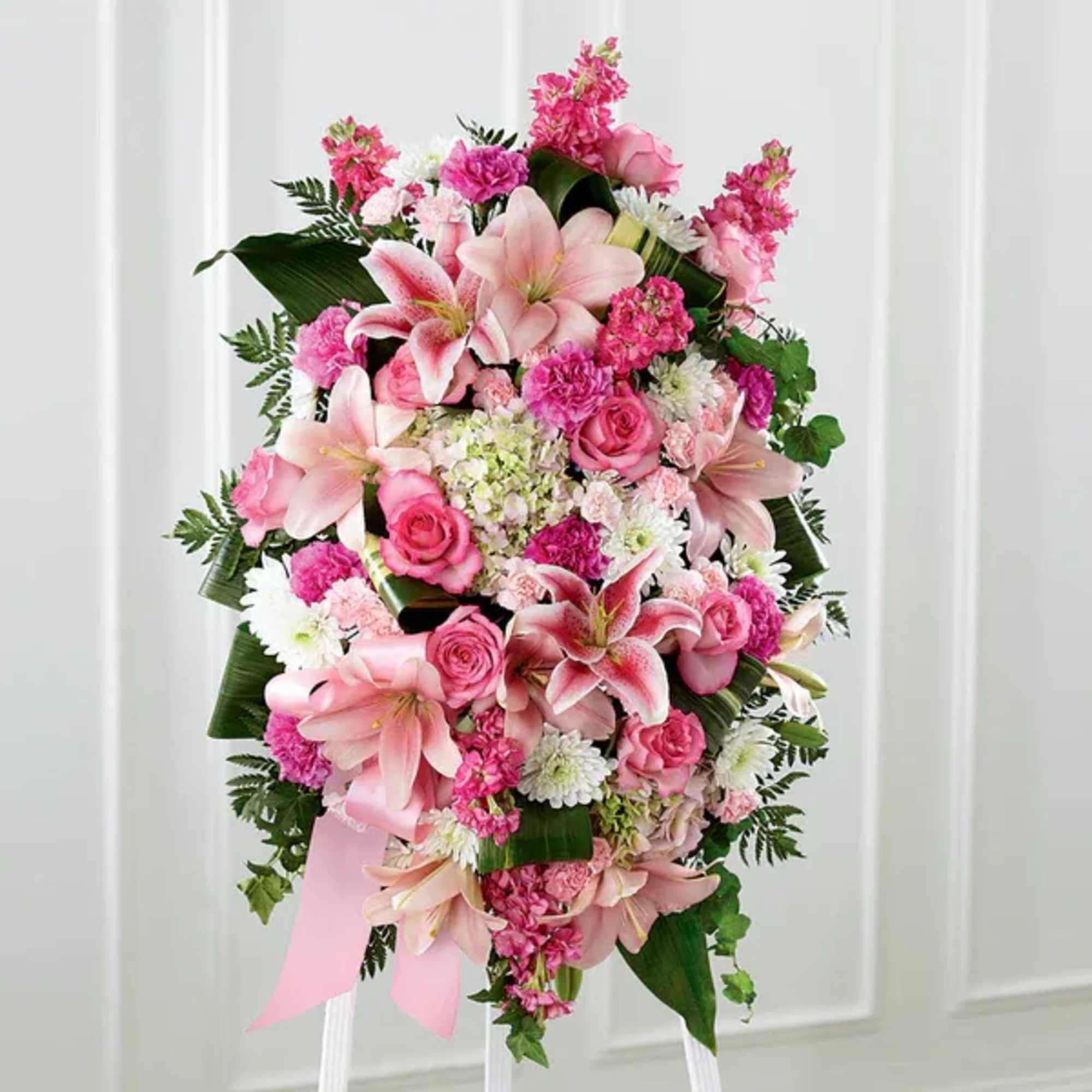 Pink floral standing spray with lilies, roses, and carnations