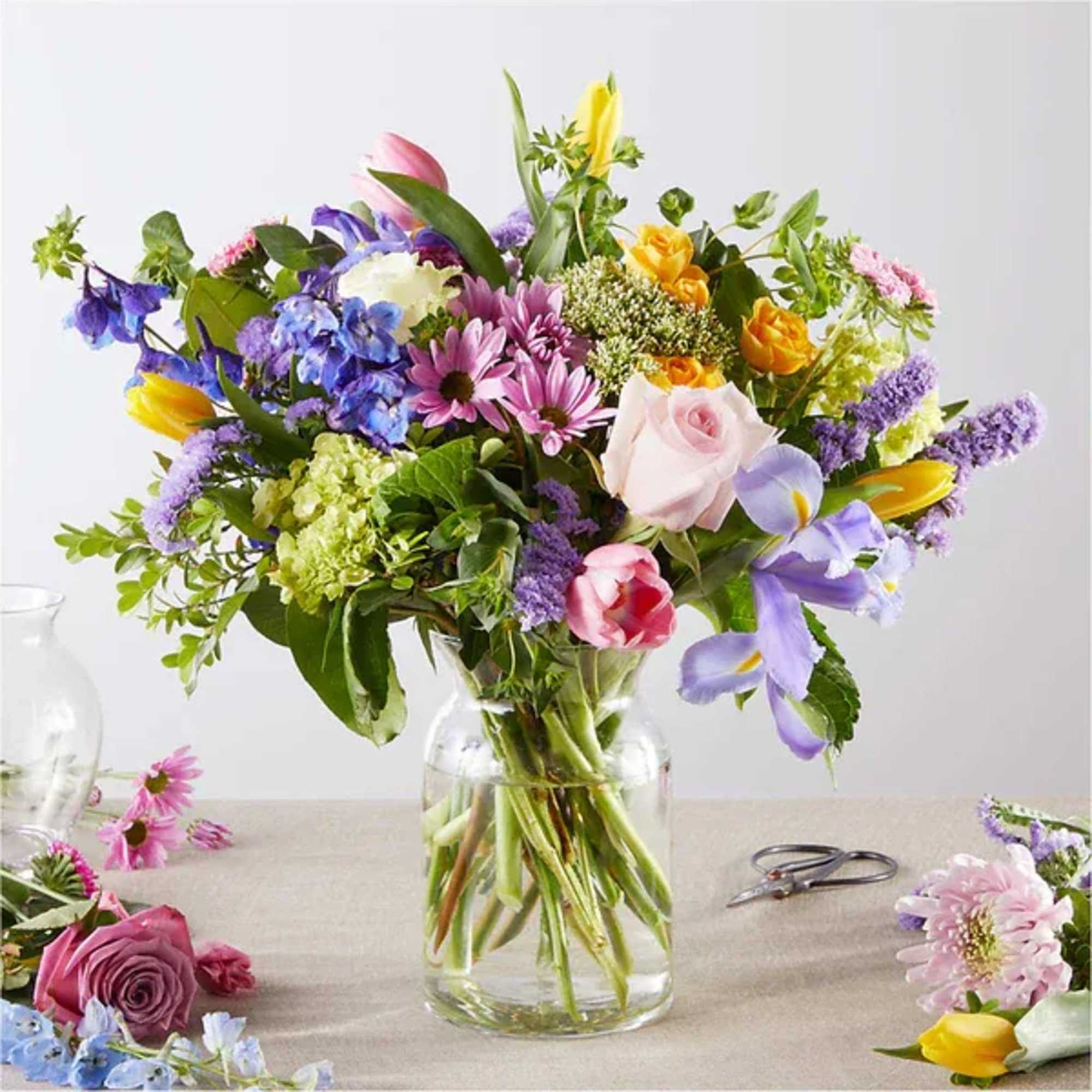 Mixed bouquet of colorful flowers in a clear glass vase