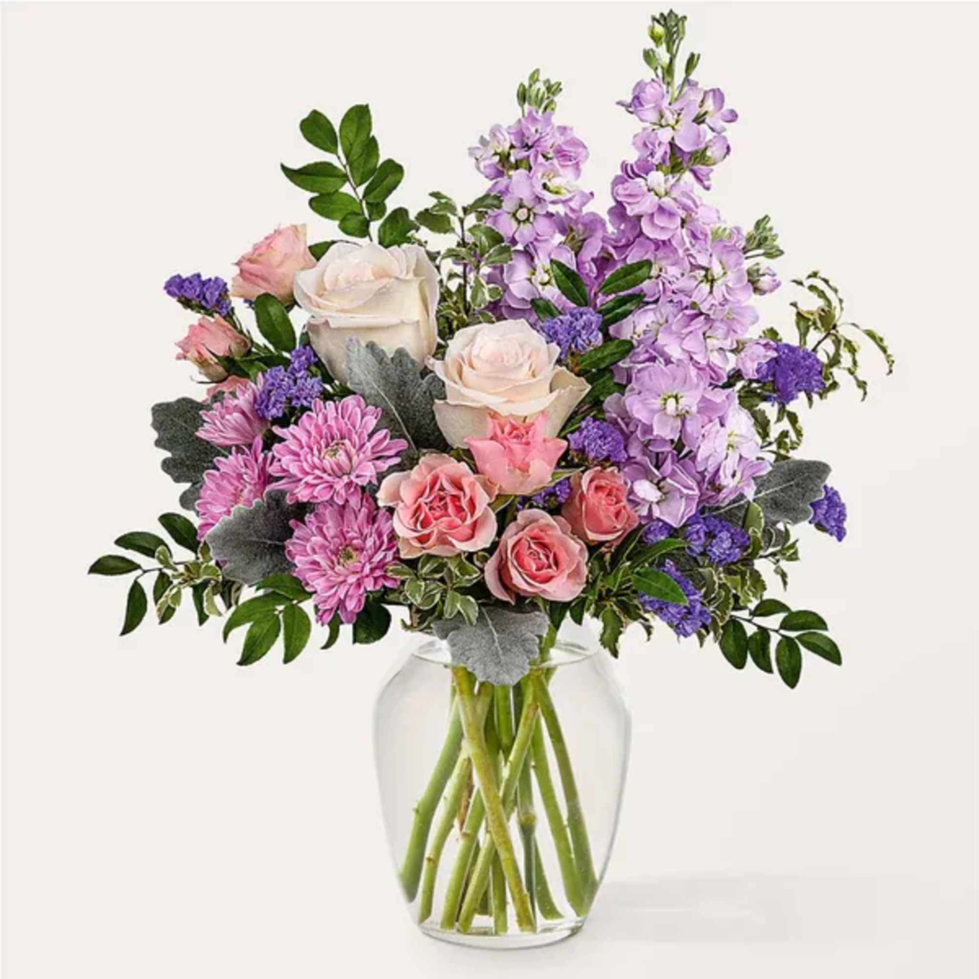 Bouquet of pink and lavender flowers in a clear glass vase