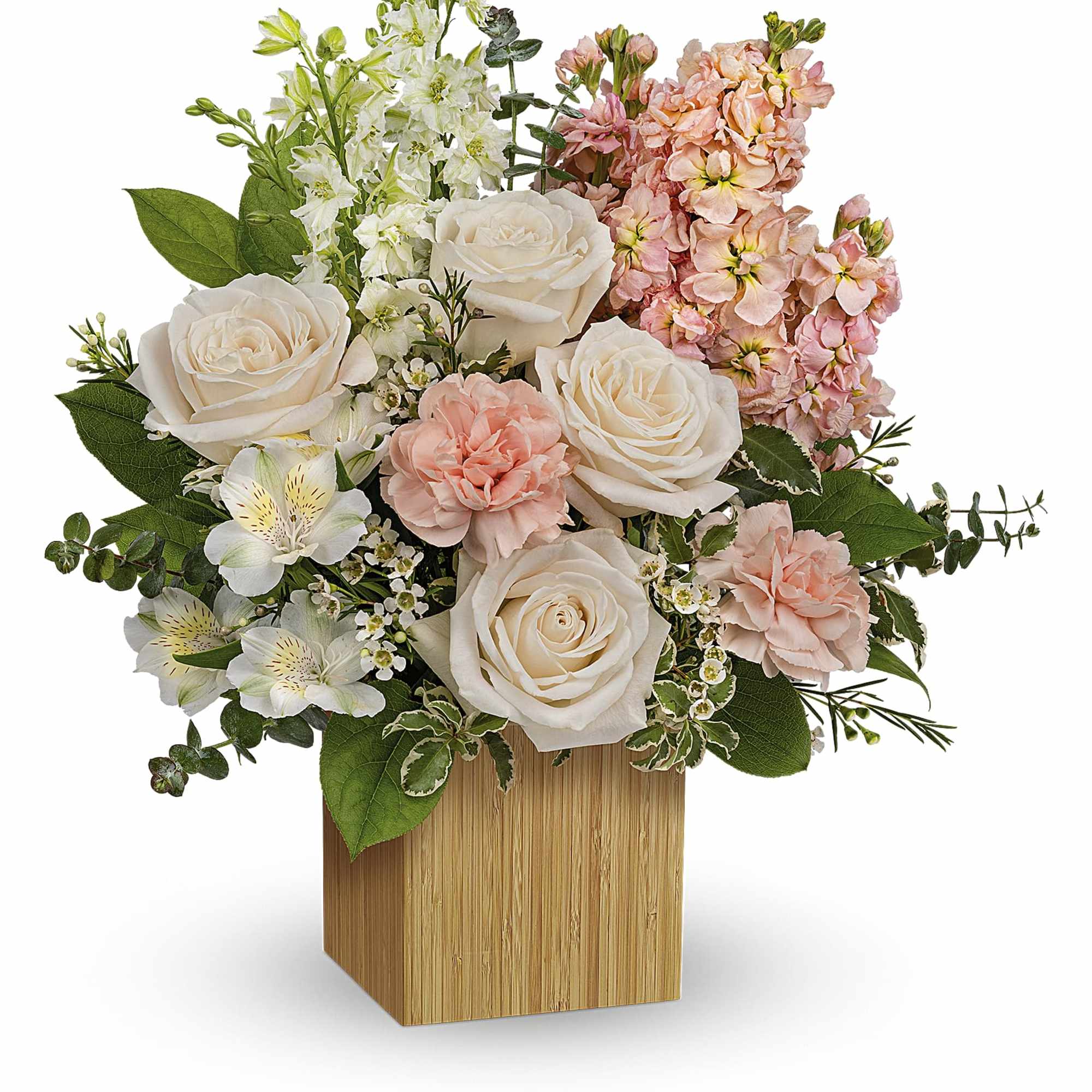 Bouquet of white roses and pink flowers in a wooden cube vase