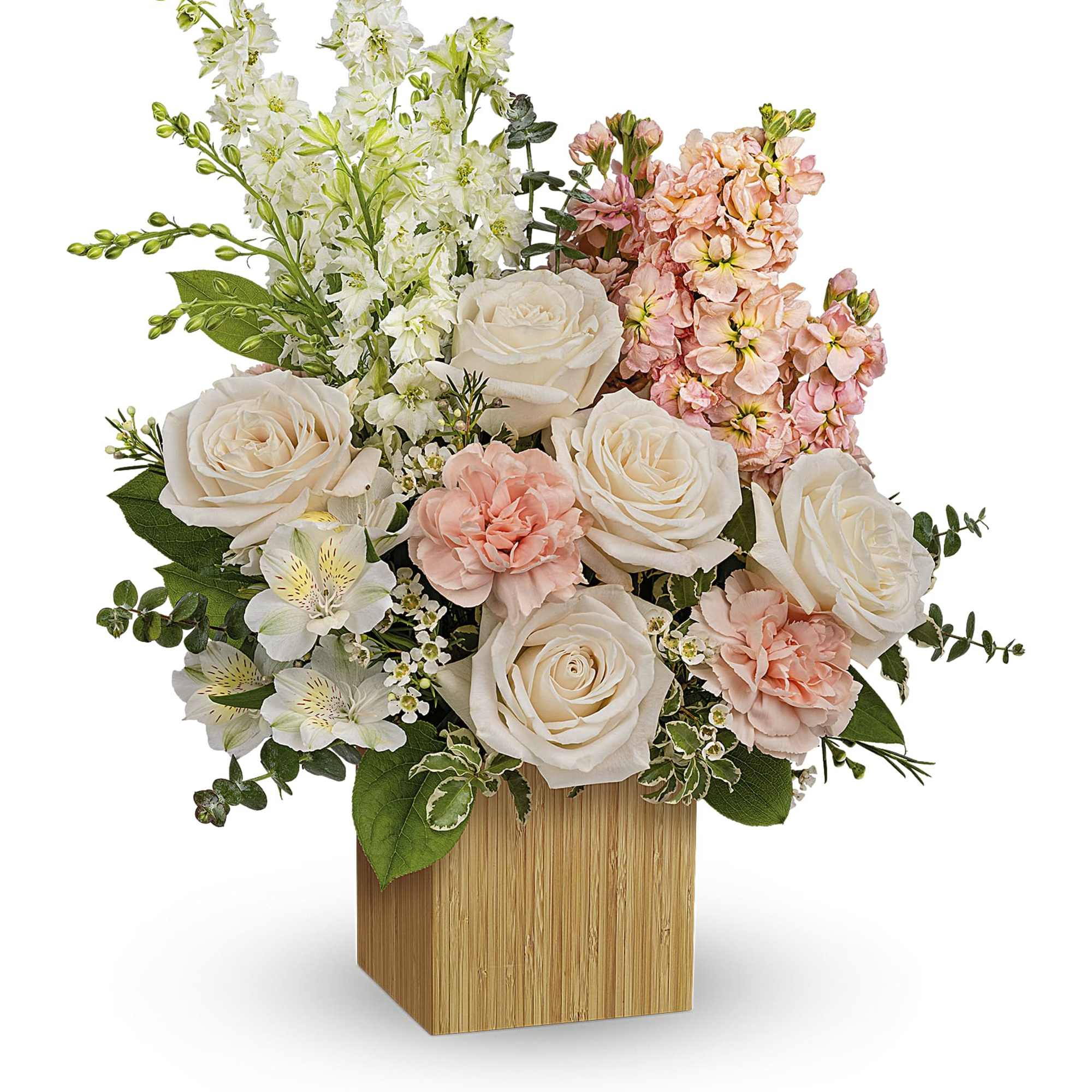 Bouquet of white and blush flowers in a wooden cube vase