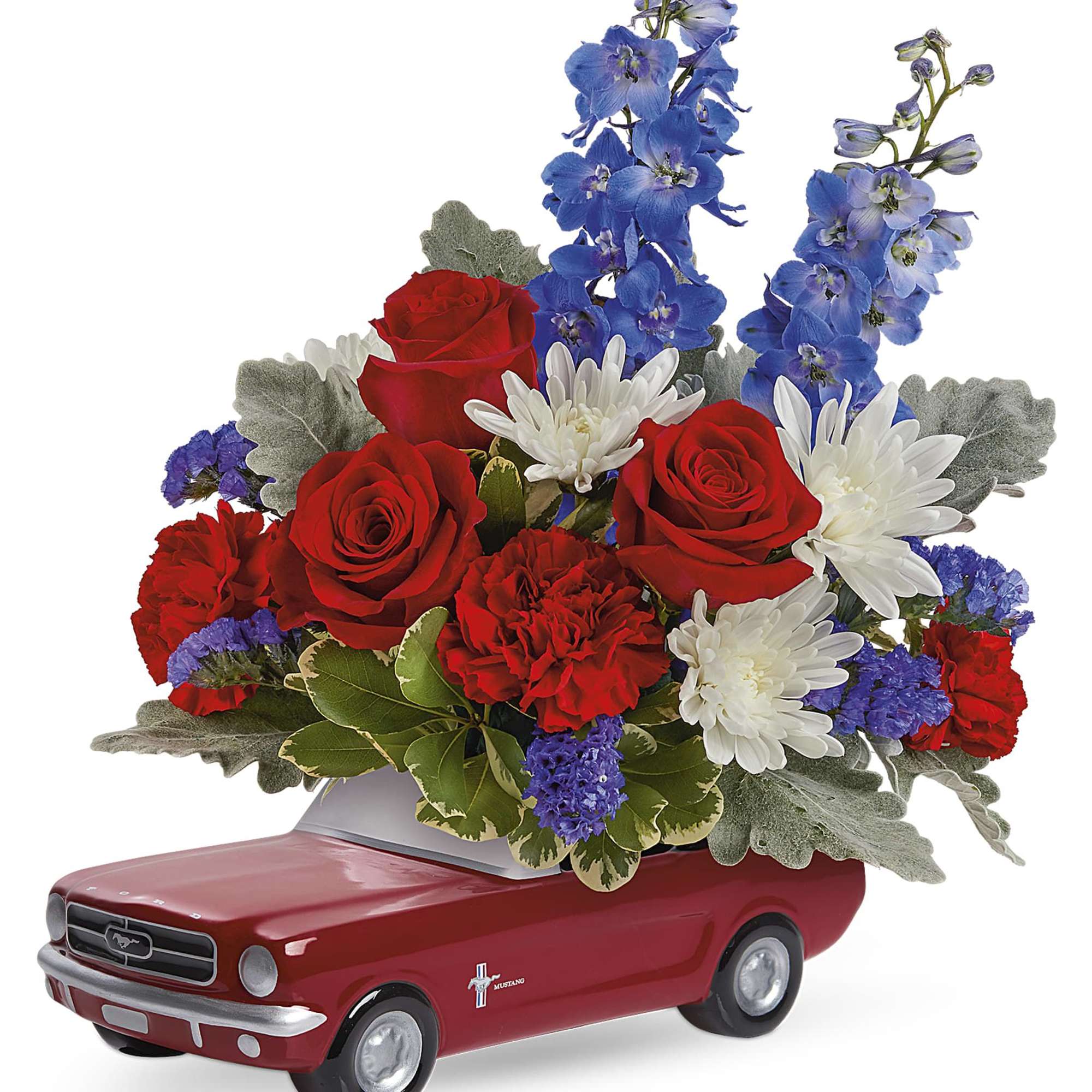 Red, white, and blue floral arrangement in a red Mustang-shaped container