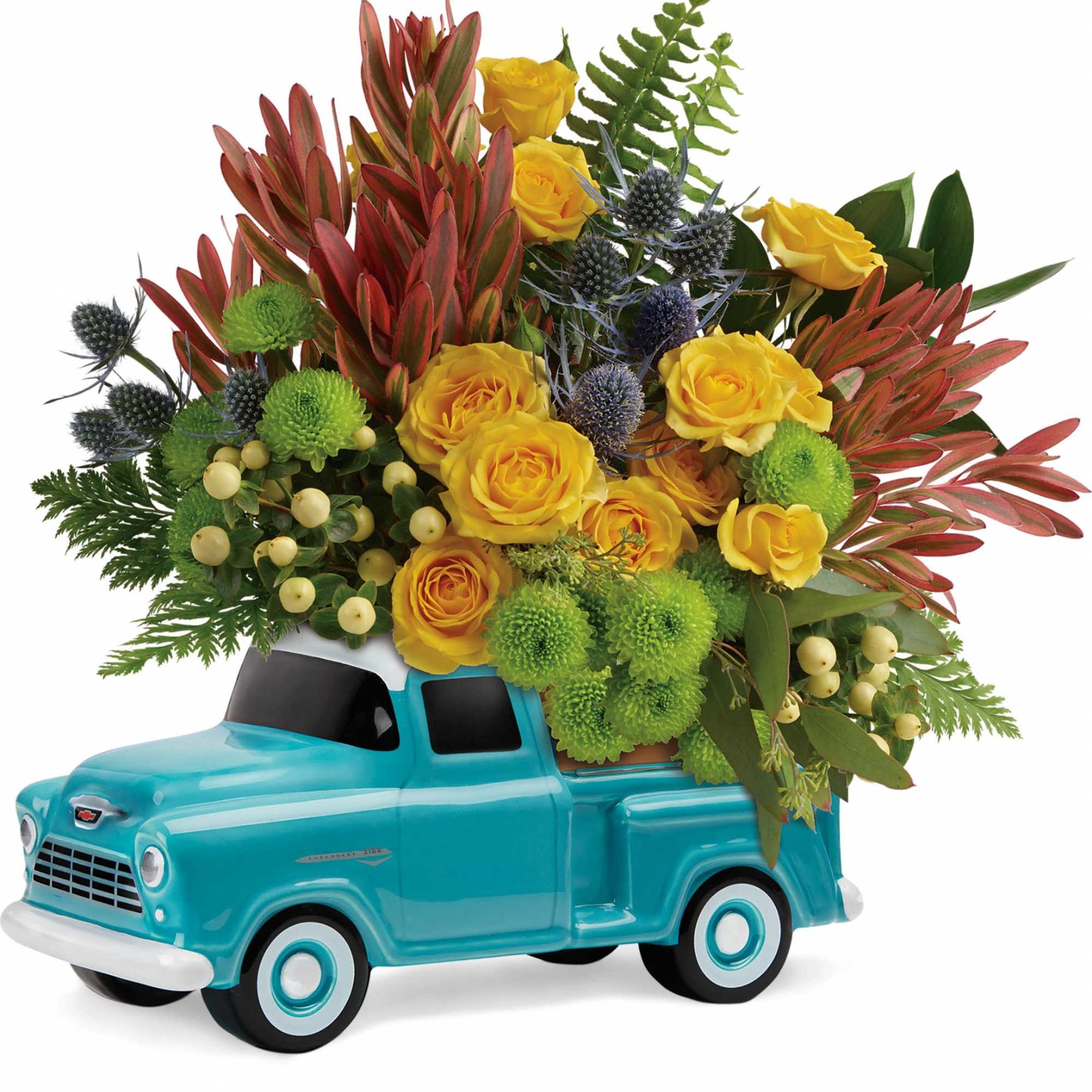Yellow roses and green pompons arranged in a turquoise toy truck
