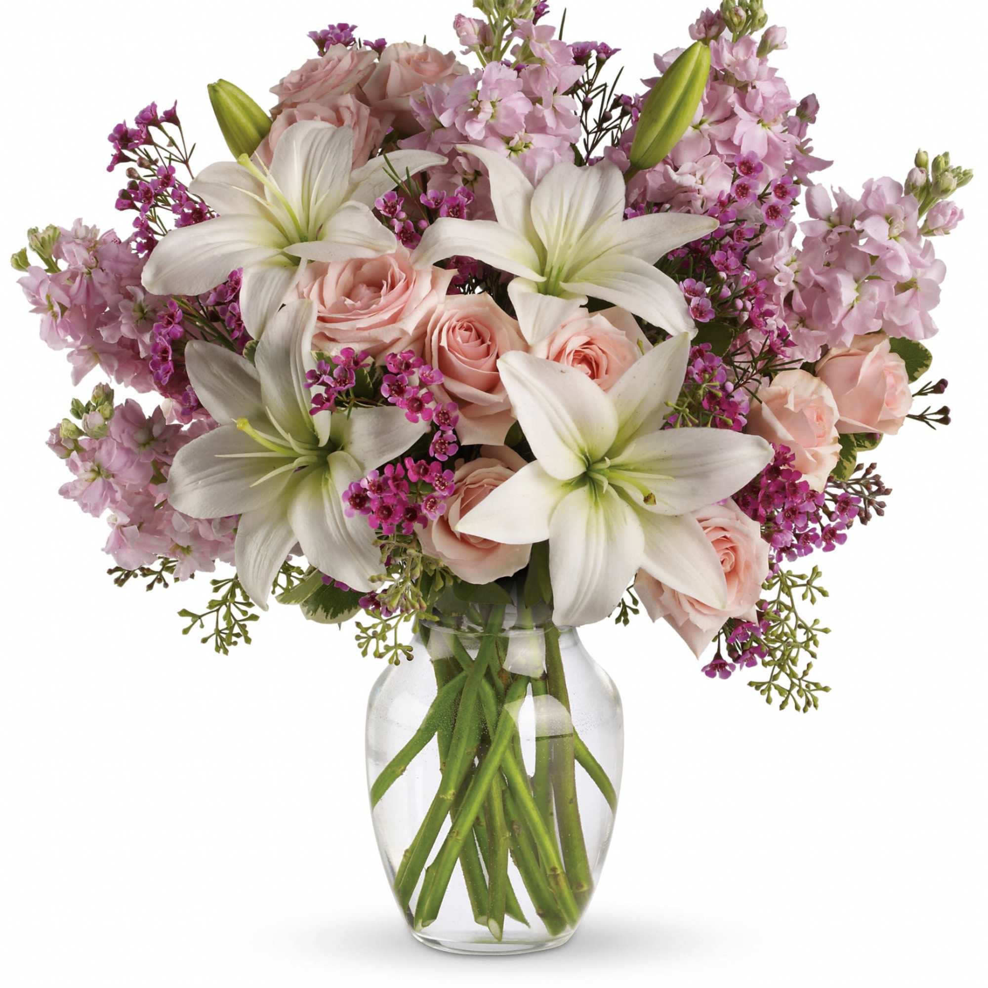 Pink roses and white lilies in a clear glass vase
