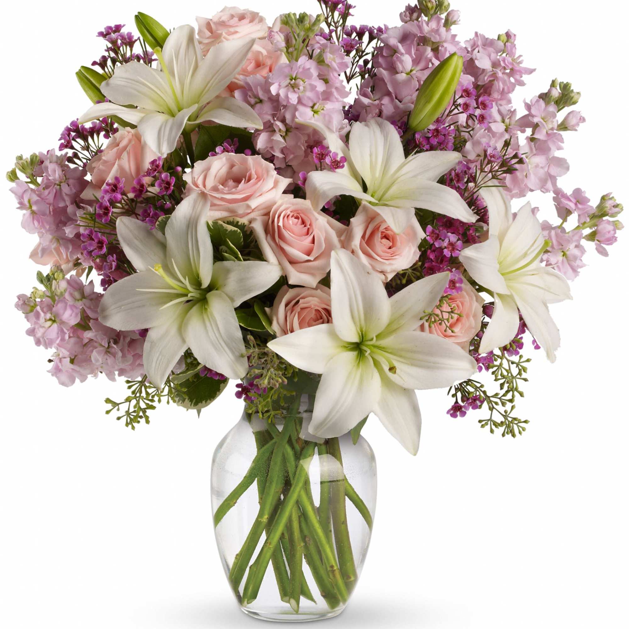 Pink roses and white lilies in a clear glass vase