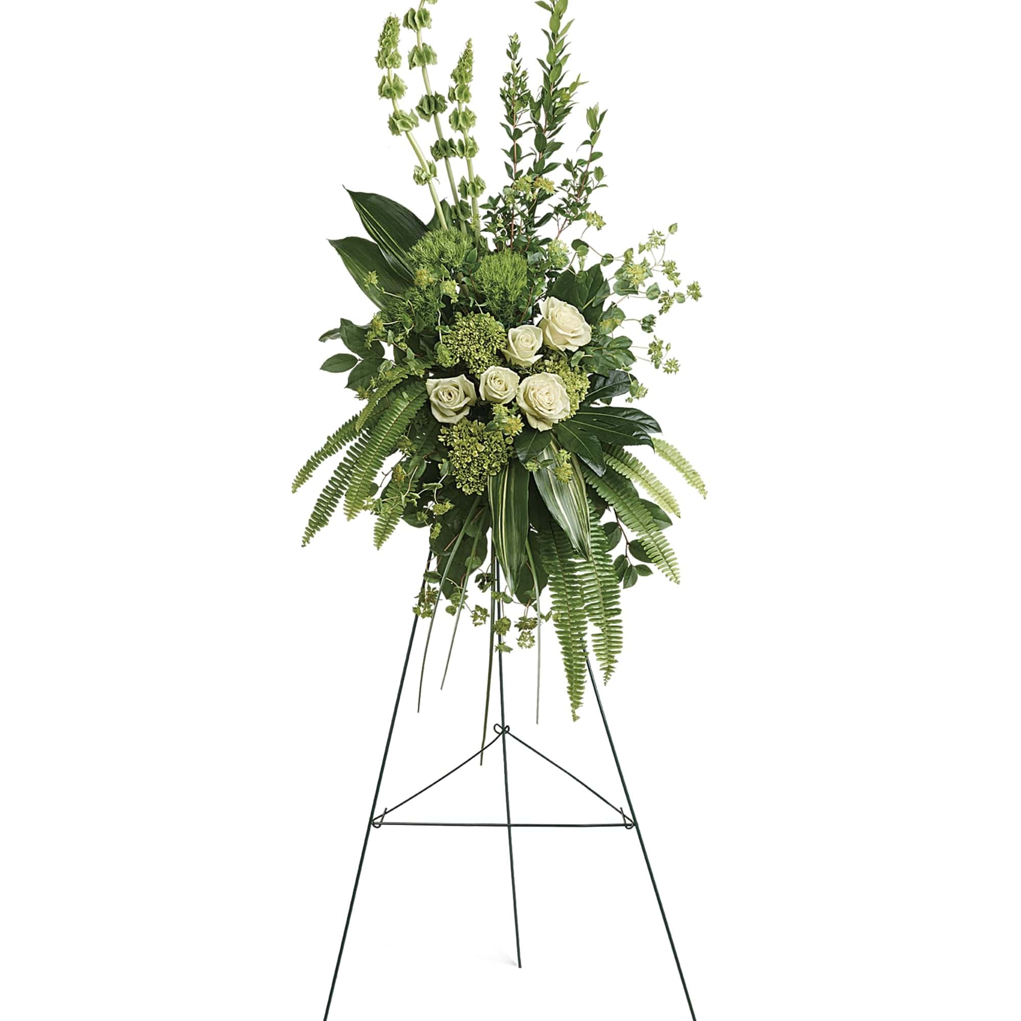 Tall white rose standing spray on a metal easel with lush greenery