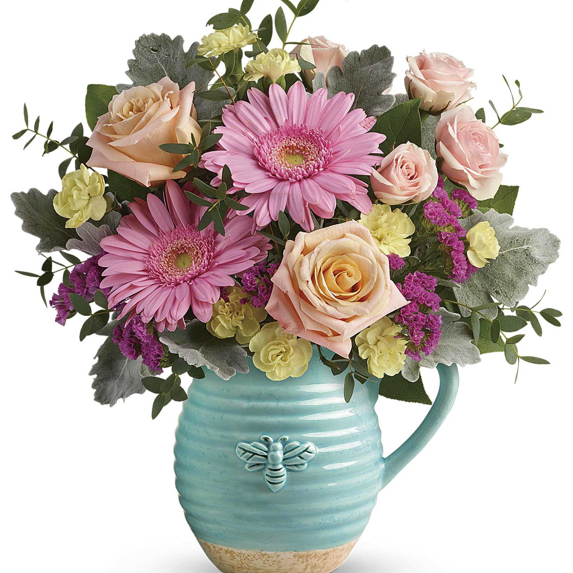 Pink gerbera daisies and roses in a turquoise mug vase