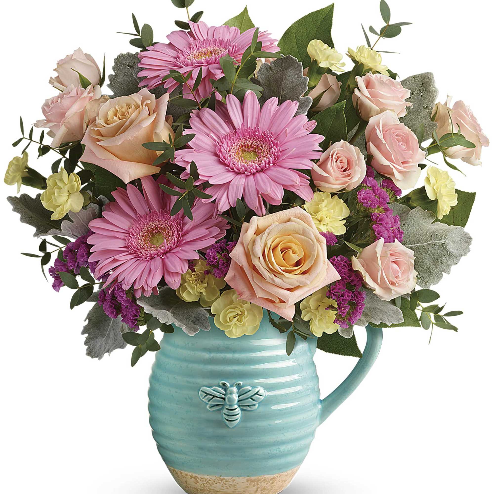 Pink gerberas and roses arranged in a turquoise pitcher vase