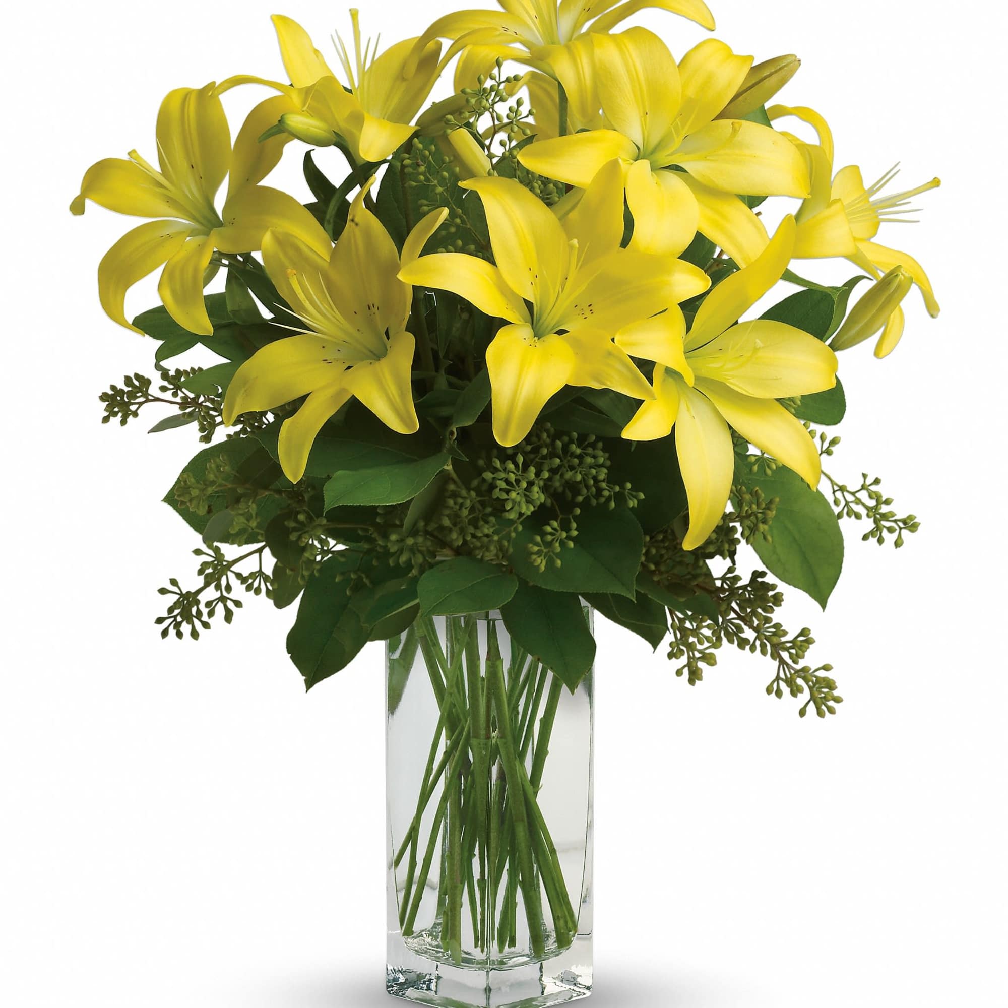 Yellow lilies arranged in a clear glass vase