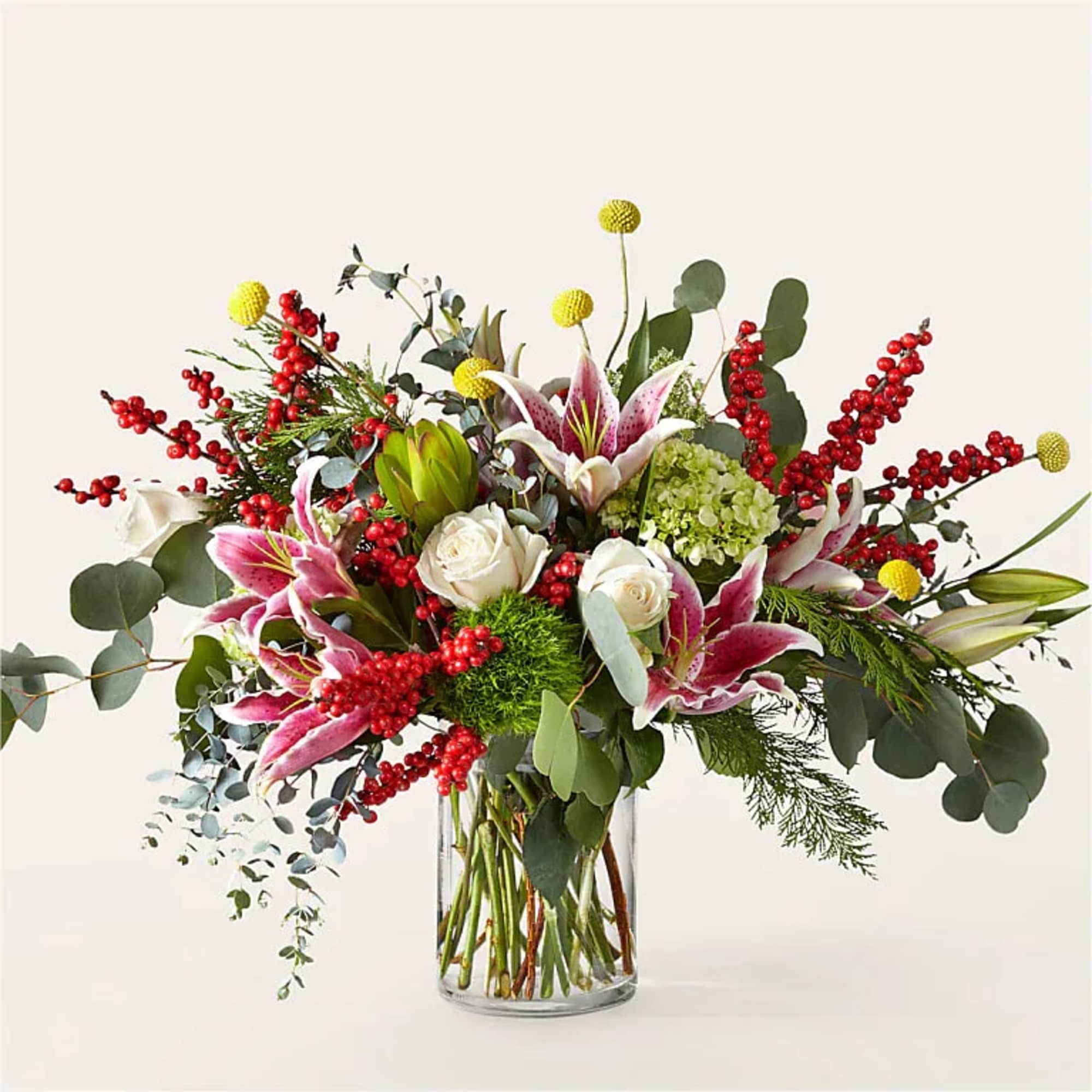 Bouquet of pink lilies and white roses in a clear glass vase