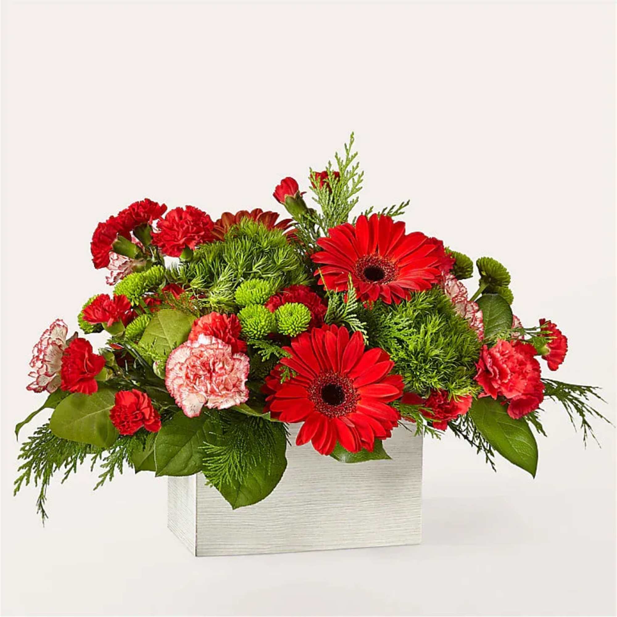 Red gerberas and carnations in a white square vase