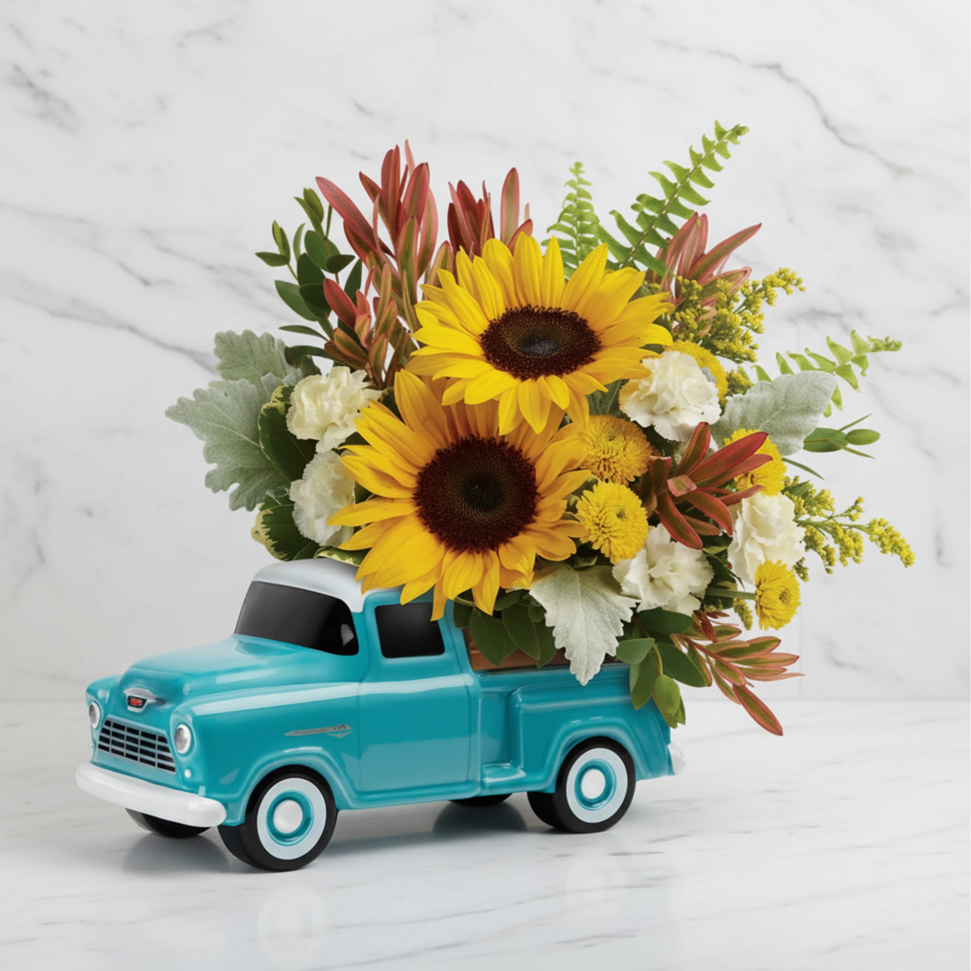 Sunflowers arranged in a turquoise toy truck