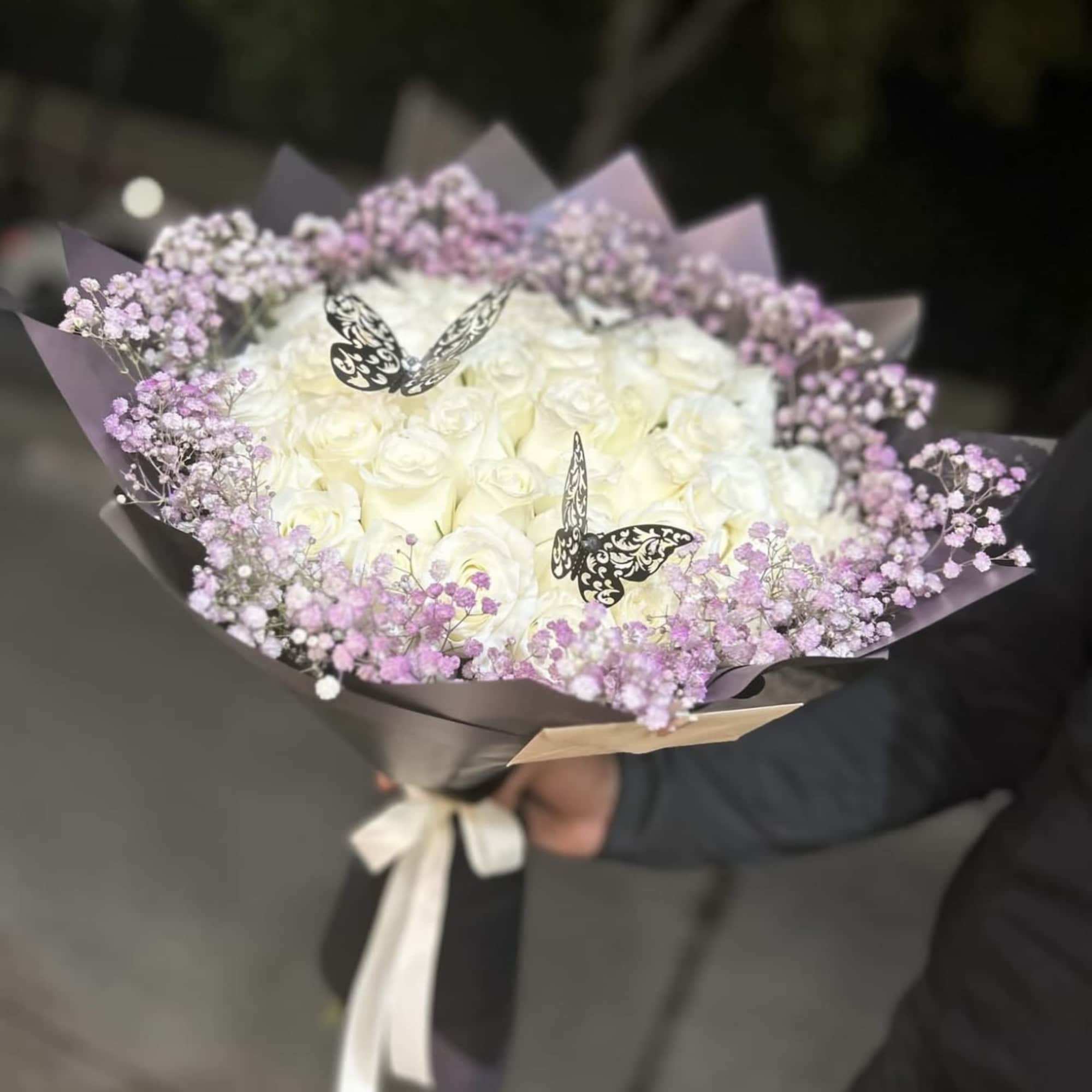Bouquet of white roses with lavender baby's breath and butterfly picks