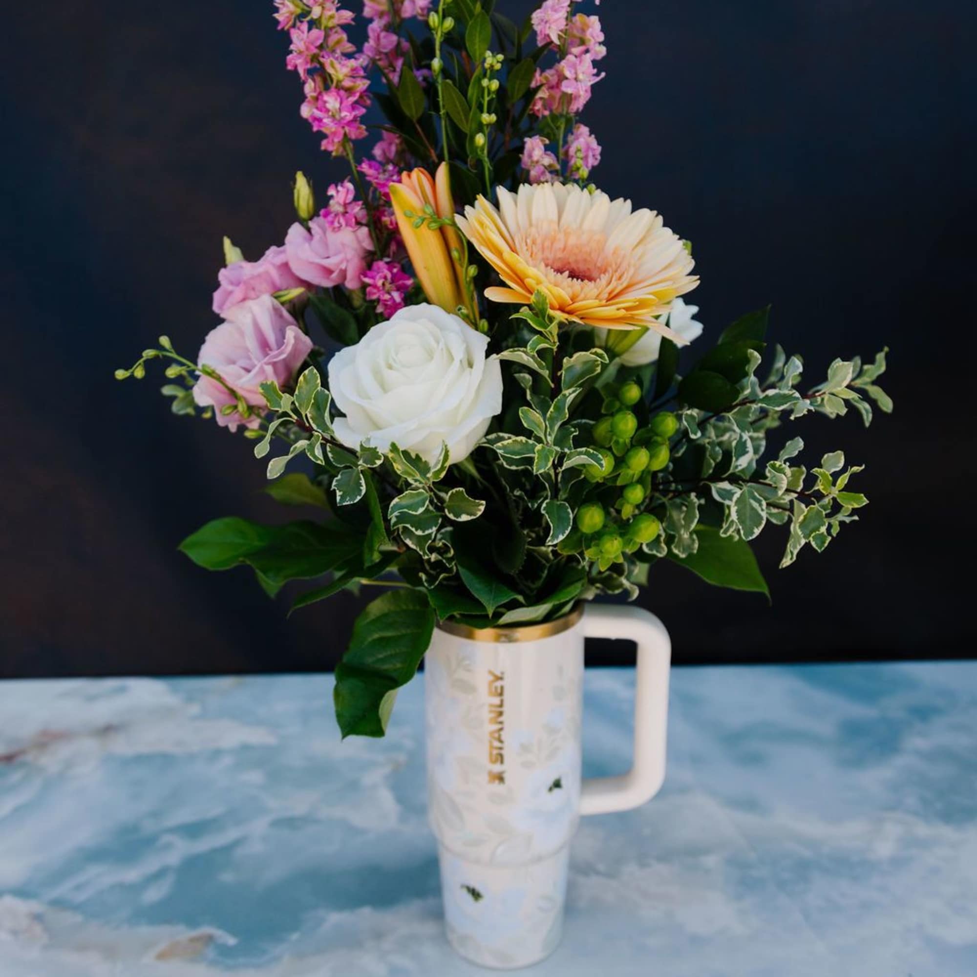 A soft, garden-inspired mix of seasonal blooms in blush, ivory, and gentle