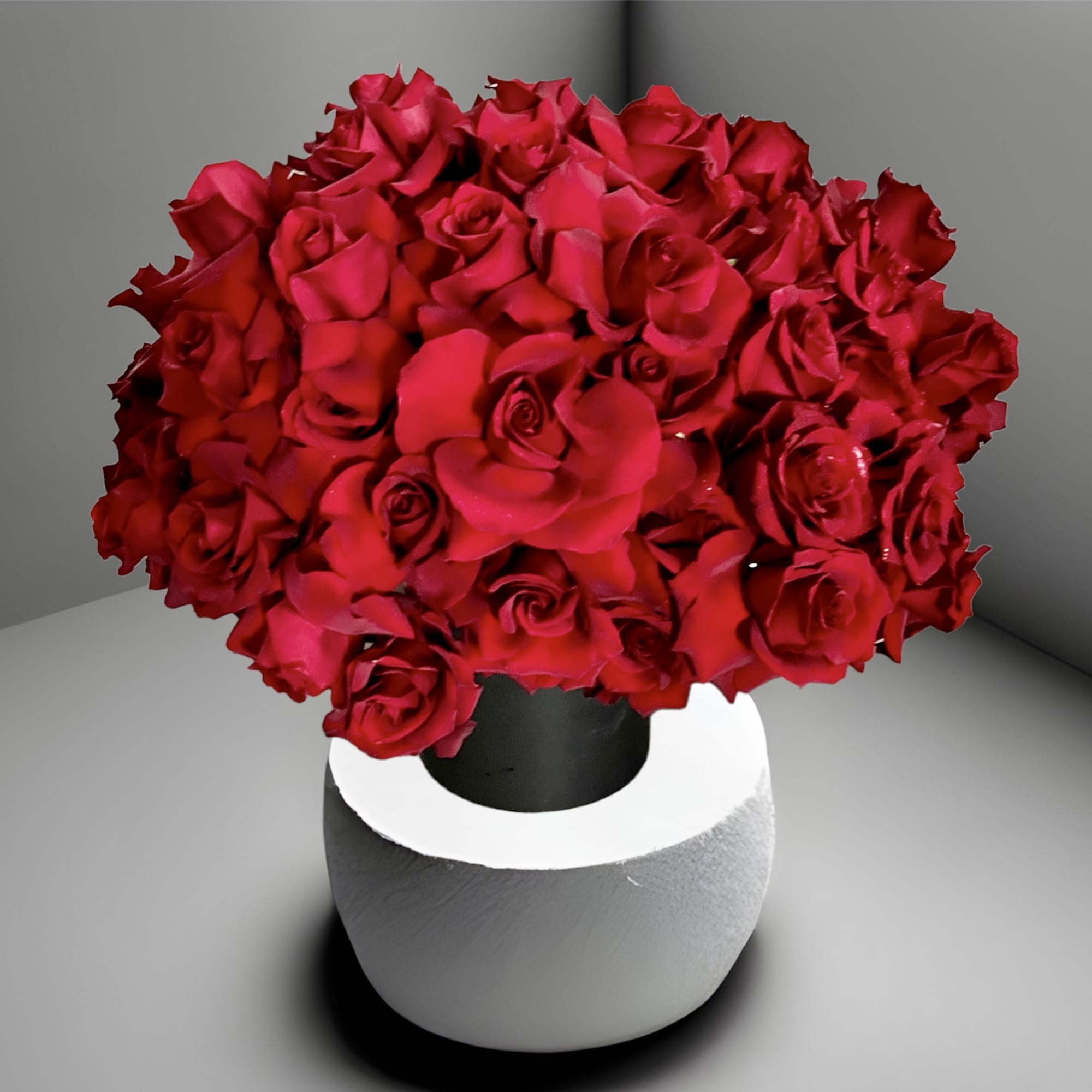 Red rose bouquet in a white and black vase