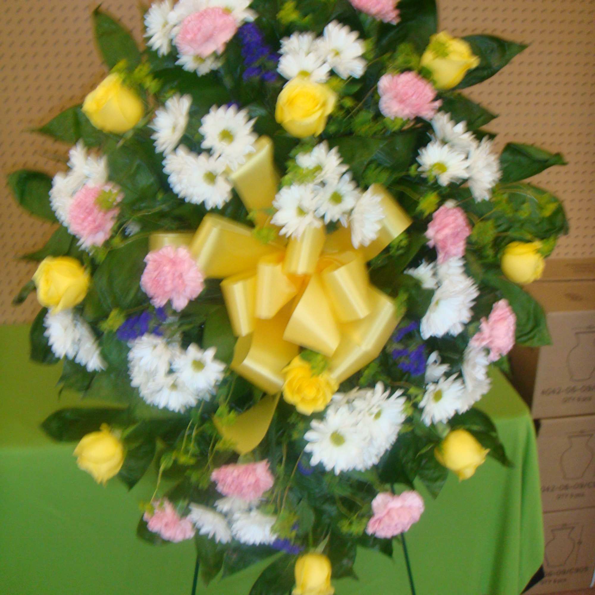 Standing floral wreath with yellow roses, white daisies, and pink carnations, photo 2 of 2