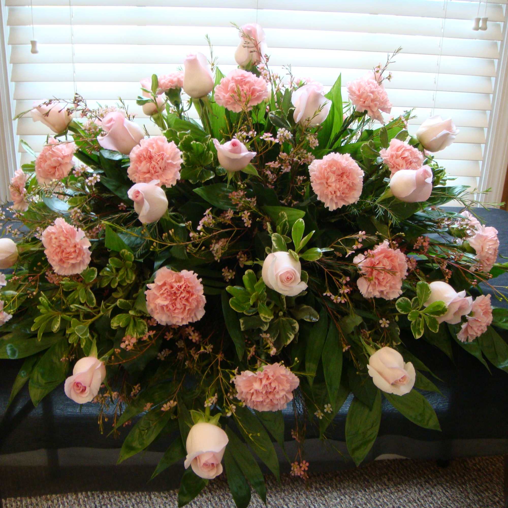 Large pink and white floral arrangement on a table