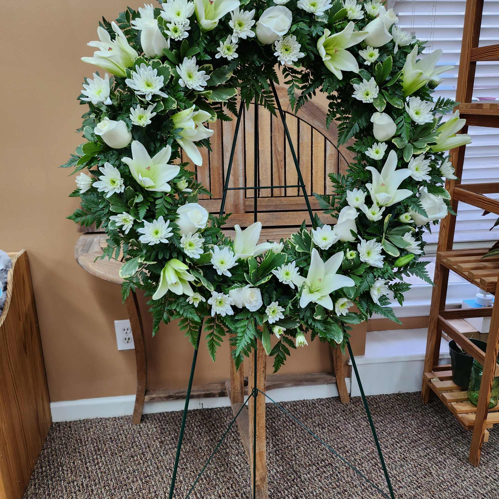 White floral wreath on a standing easel