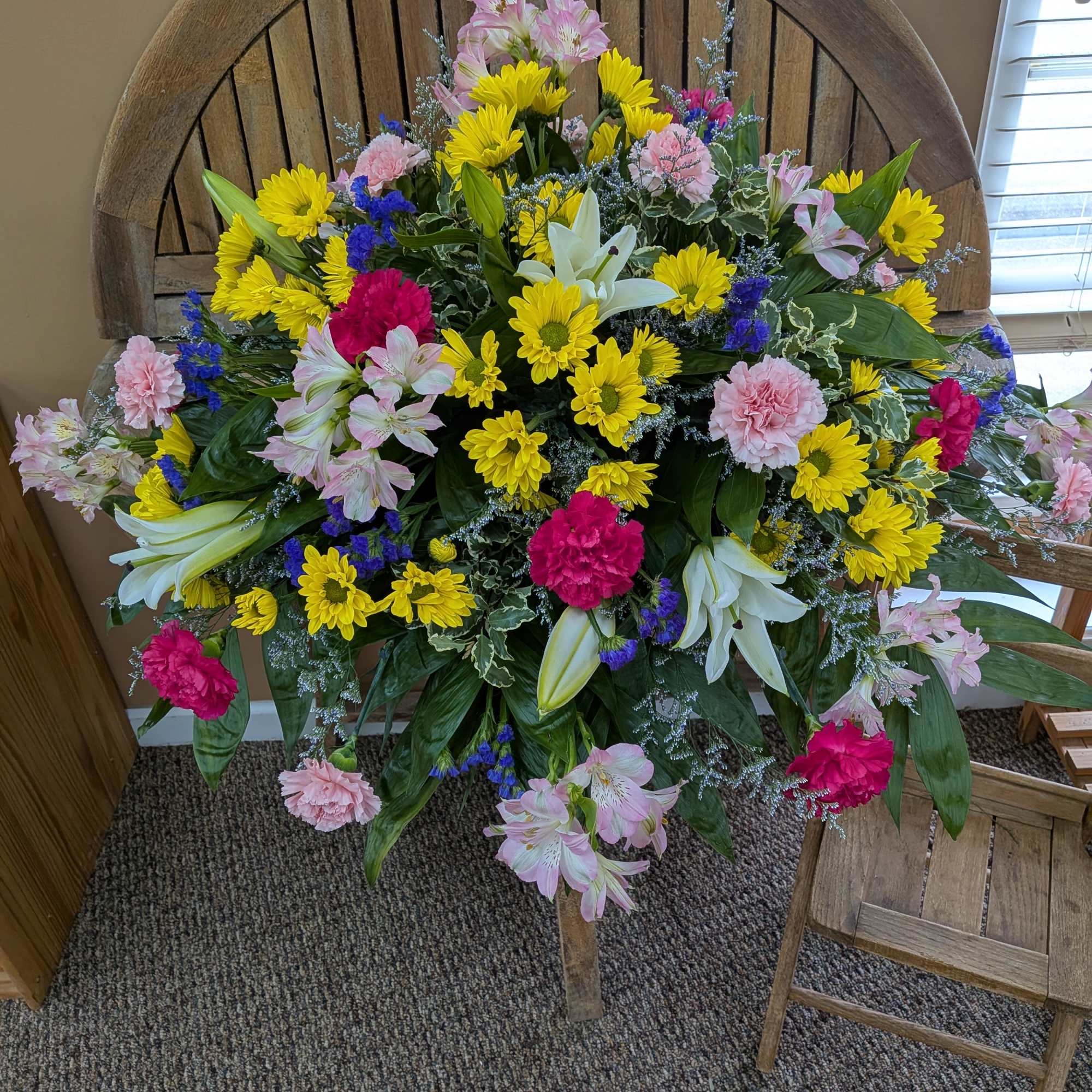Large mixed flower arrangement with yellow daisies, pink lilies, and carnations, photo 2 of 3