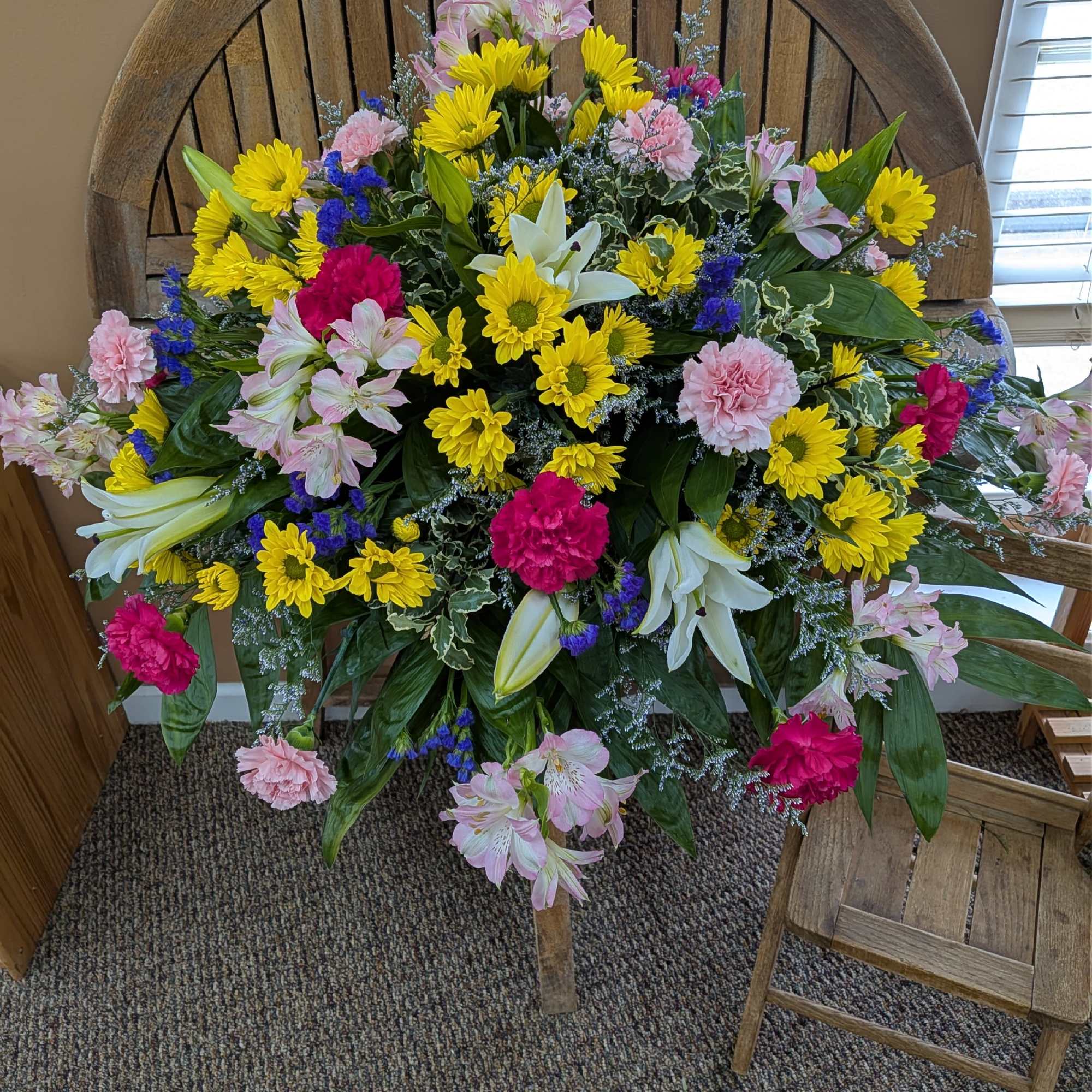Large mixed flower arrangement with yellow daisies, pink lilies, and carnations, photo 3 of 3