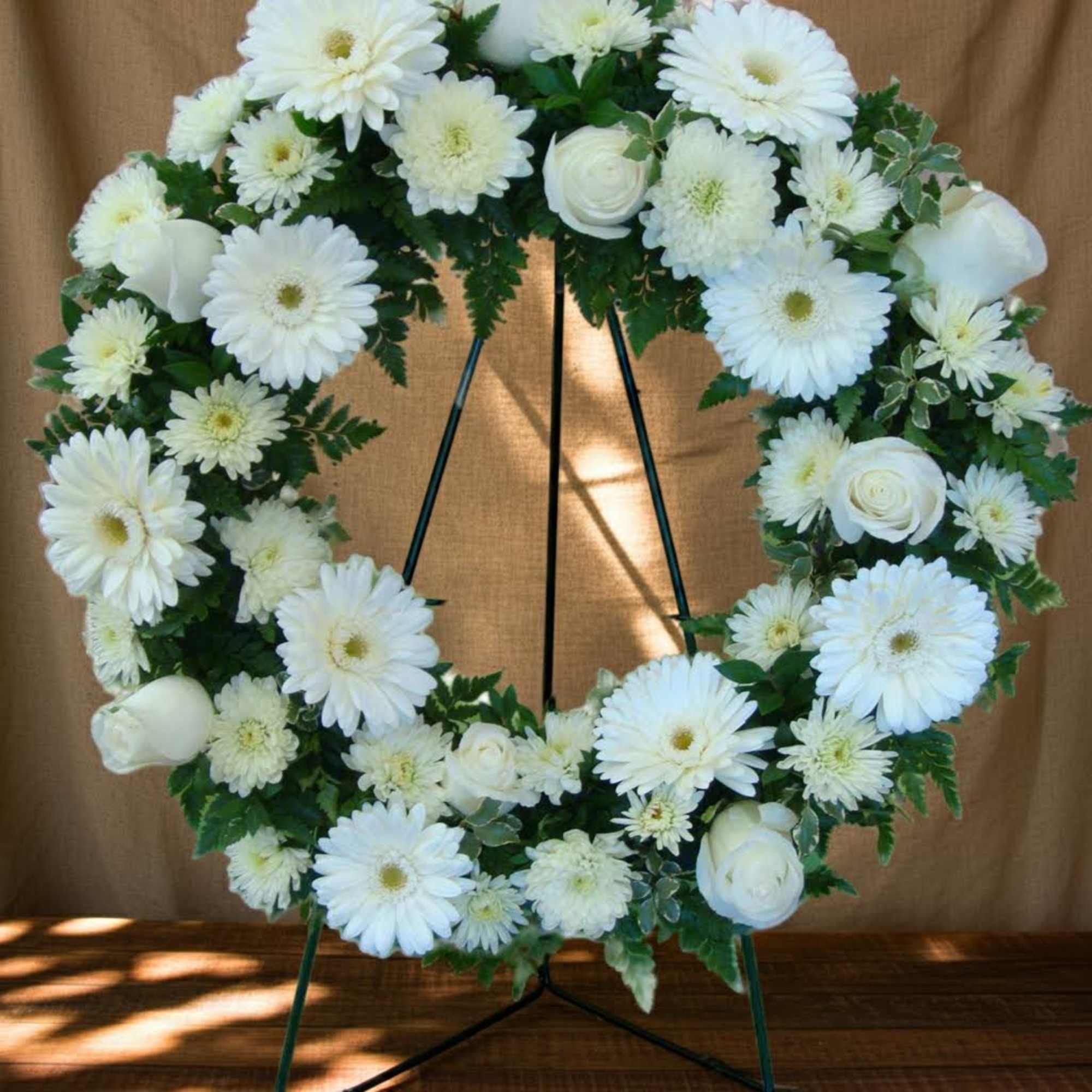 White floral wreath on a standing easel