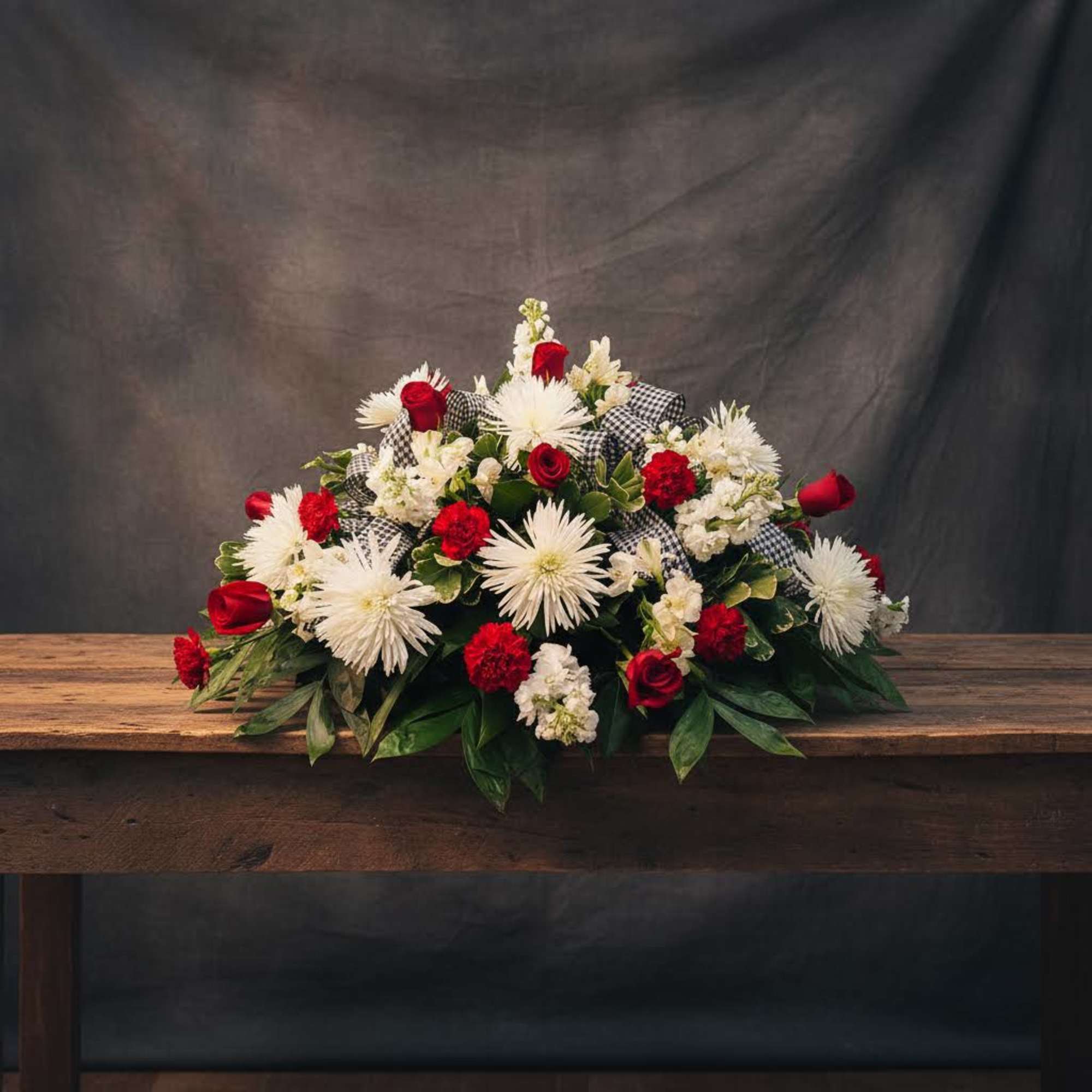 Red and white flowers with houndstooth ribbon.
