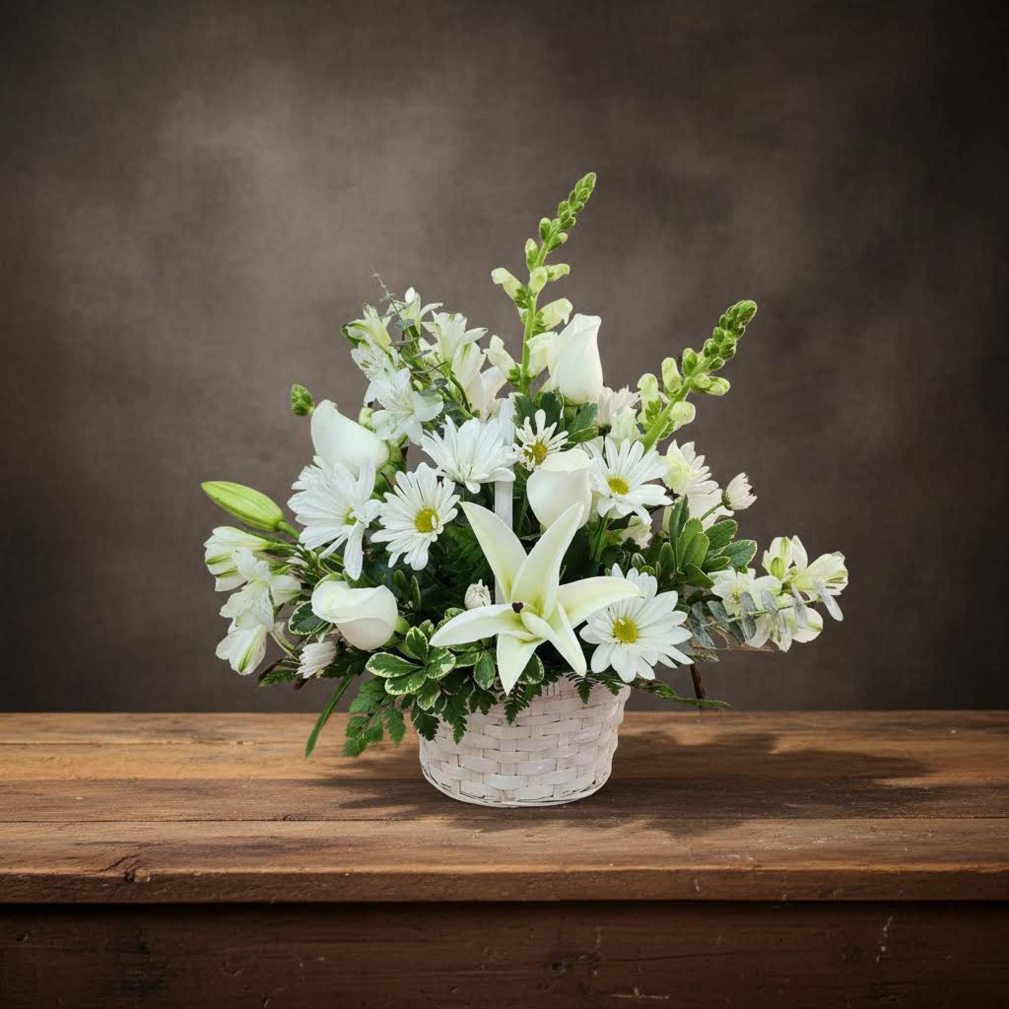 White flowers arranged in a white basket on a wooden table, photo 3 of 4