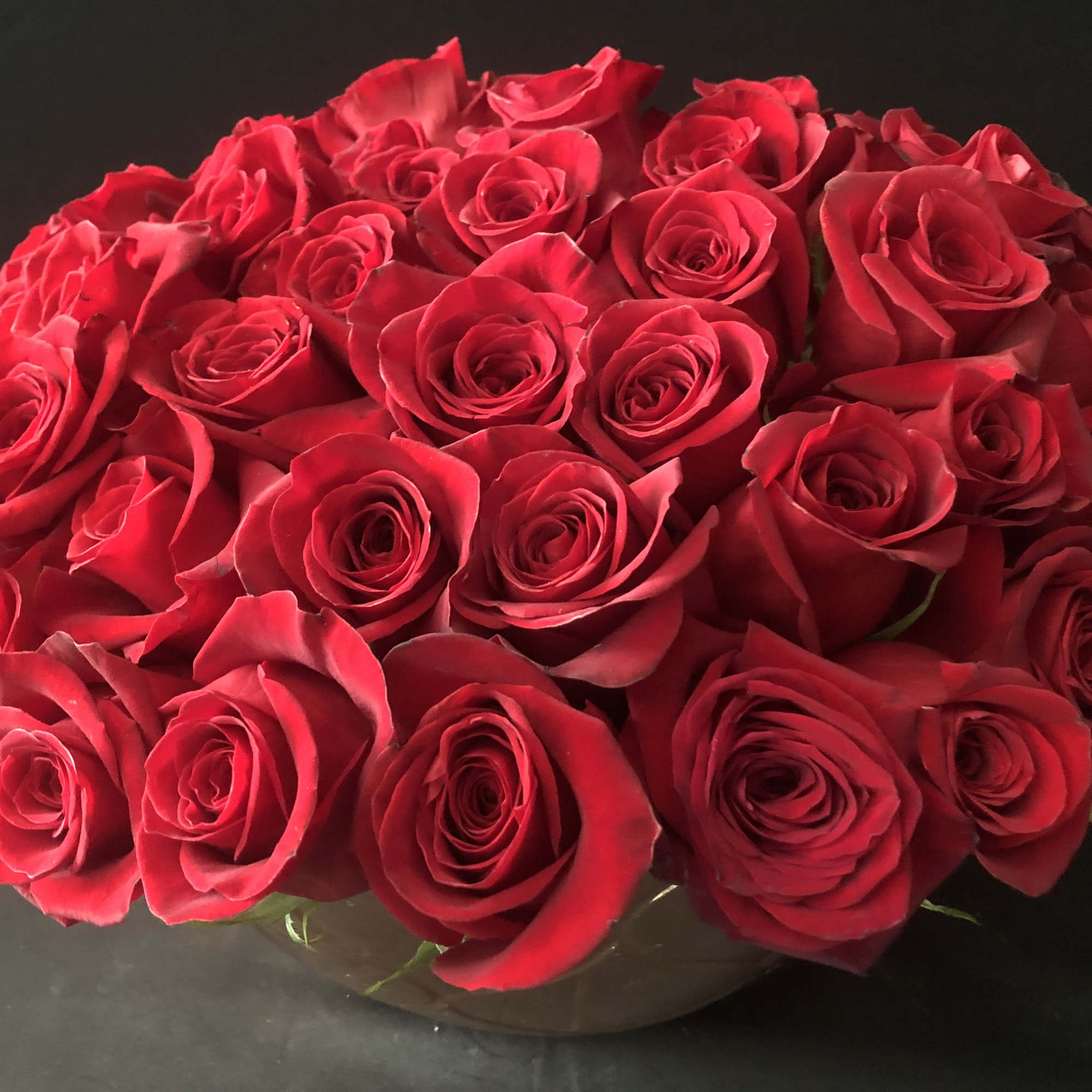 Bouquet of red roses in a low round vase