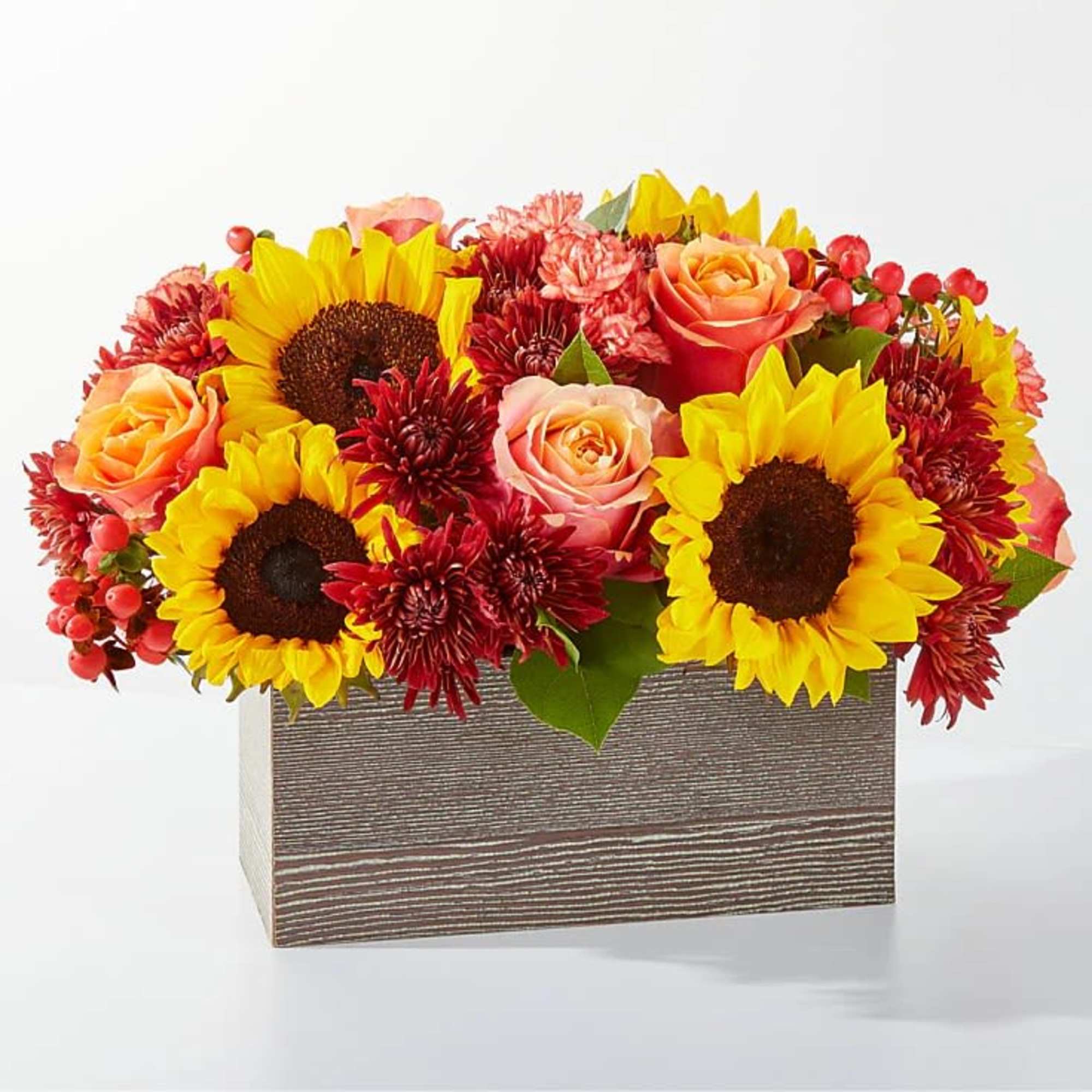 Sunflowers, roses, and red mums arranged in a rectangular wooden box