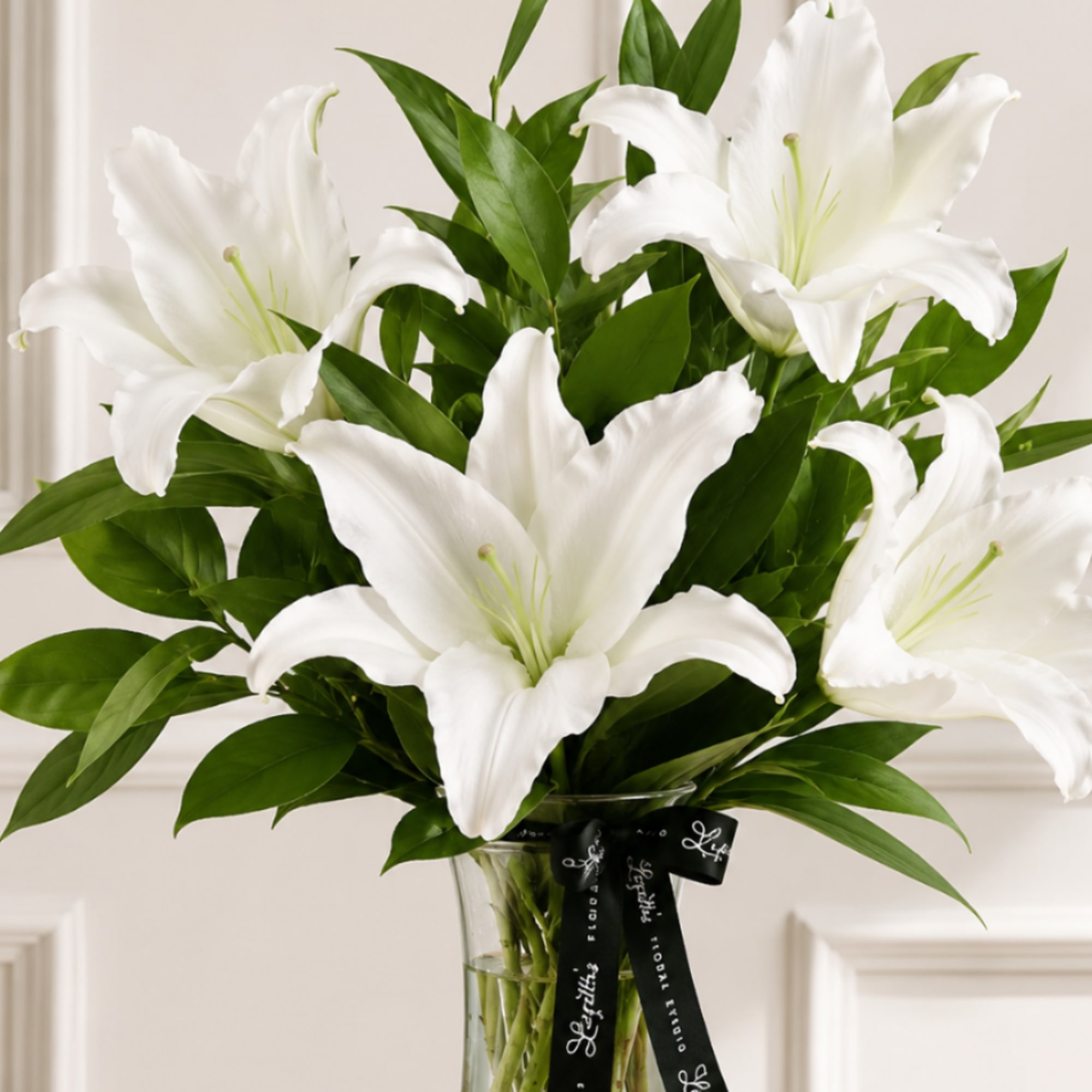 Lily &Eacute;lan is a graceful all-lily arrangement that celebrates timeless elegance with
