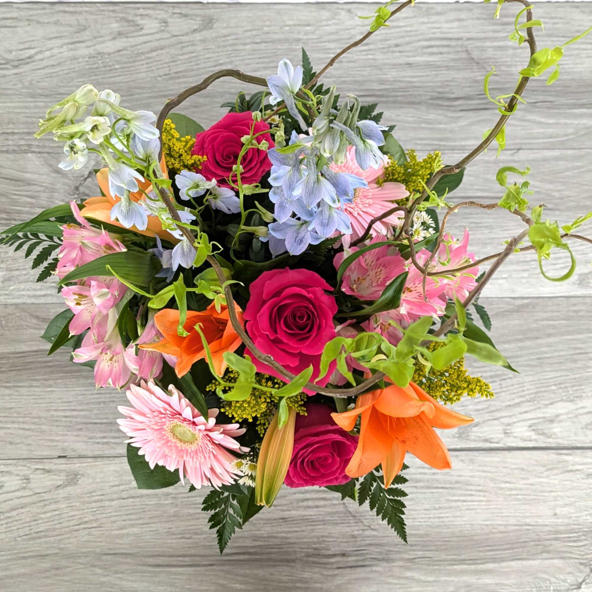 Colorful mixed bouquet with roses, lilies, and daisies