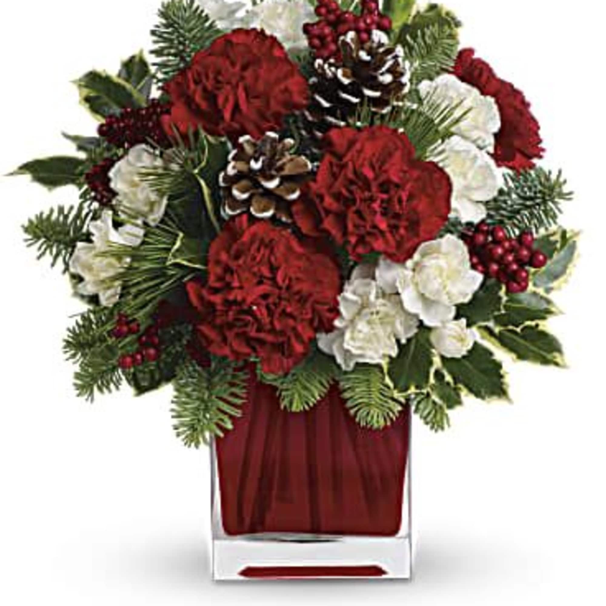 Red and white holiday bouquet in a clear square vase