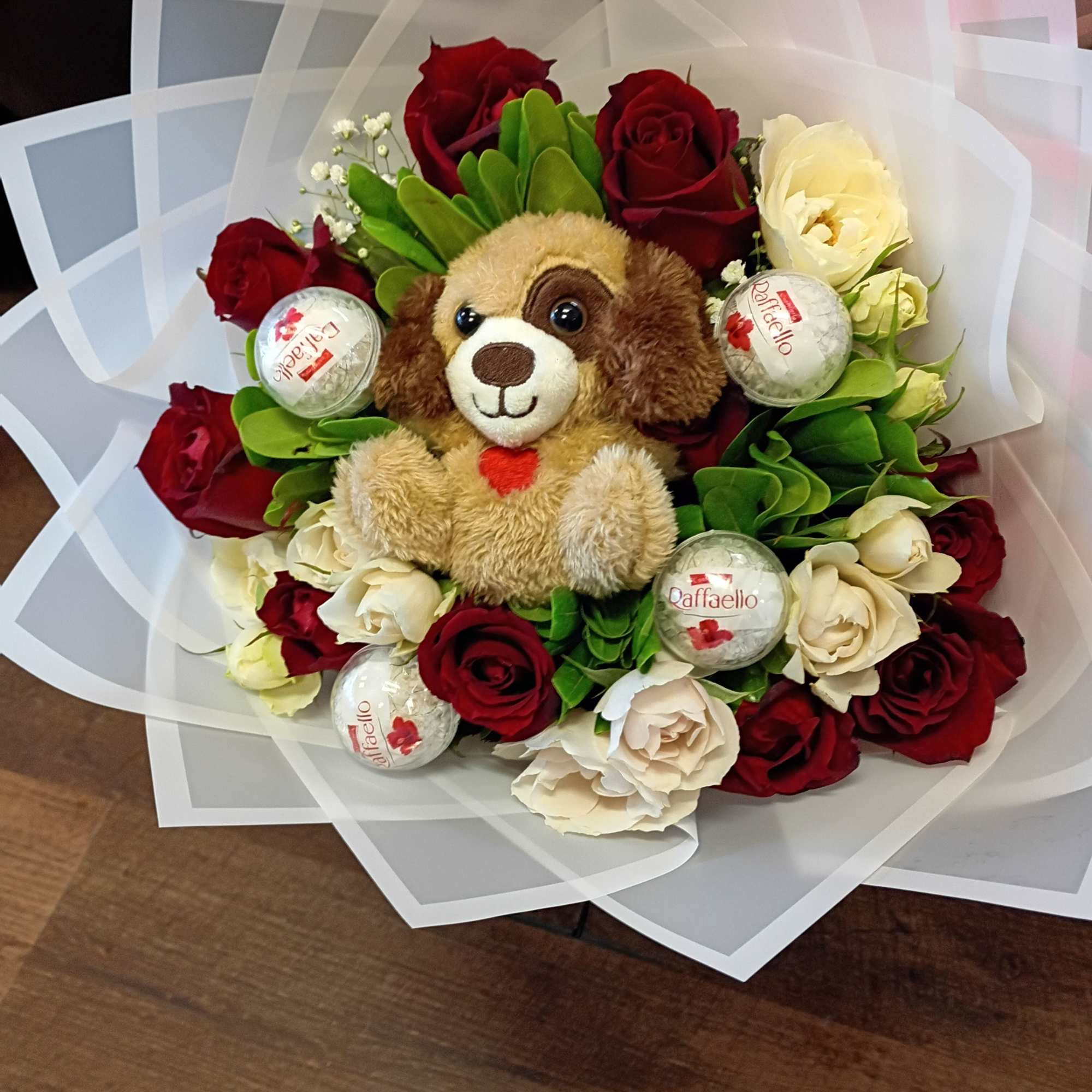 Bouquet of red and white roses with a plush dog and candy balls
