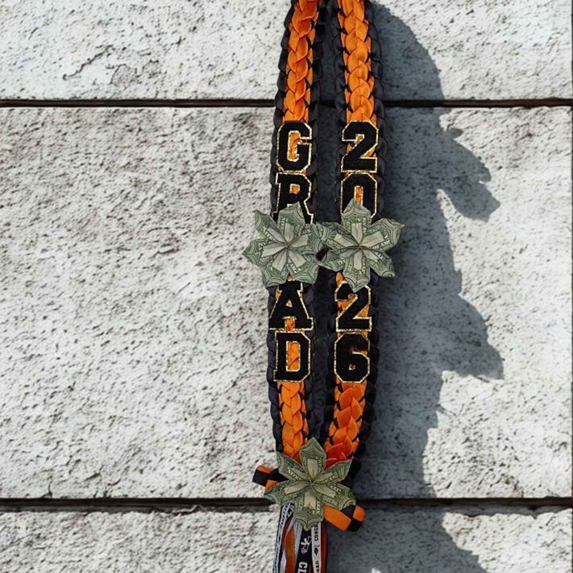 Make their graduation moment unmistakable with a braided ribbon lei in bold