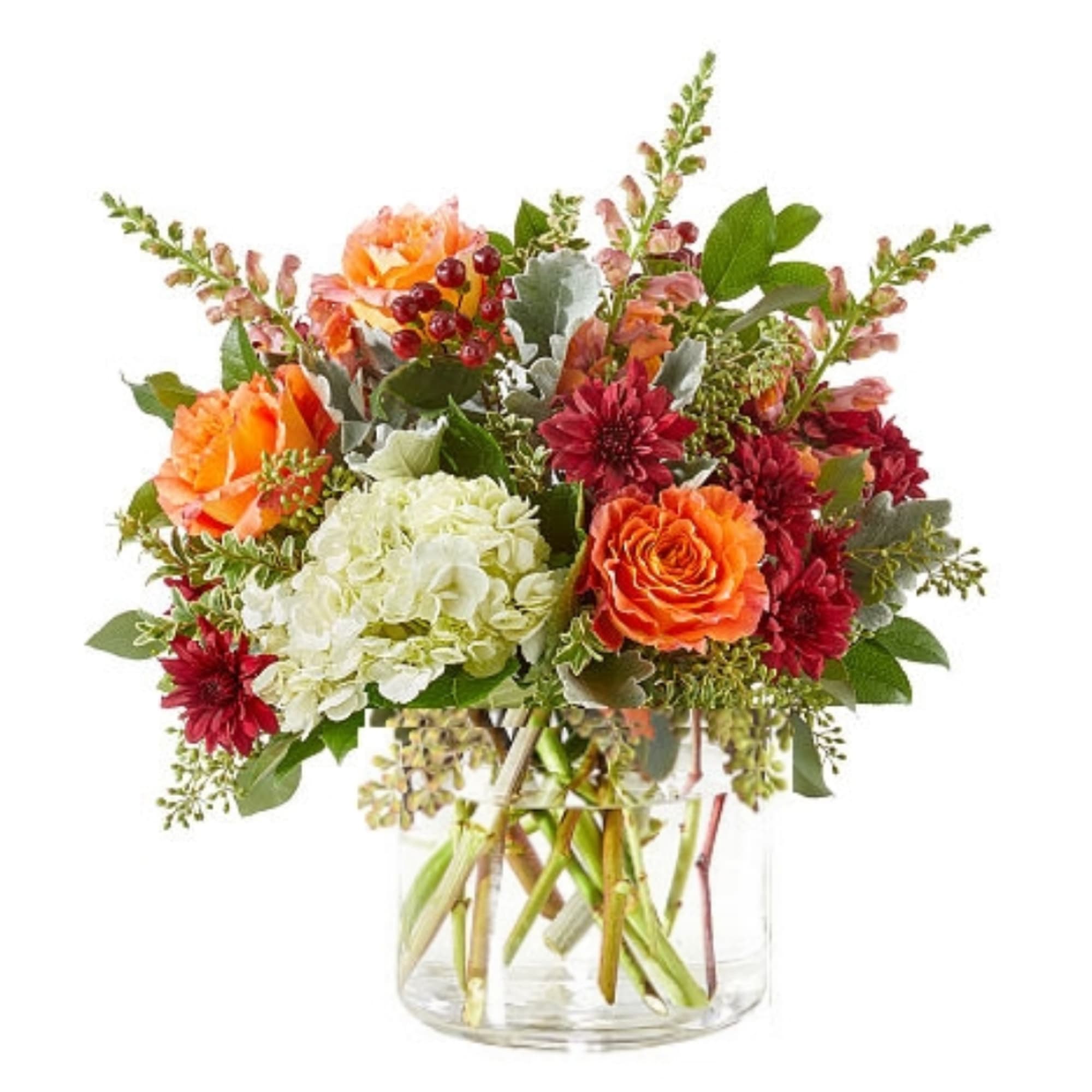 Orange and red mixed flower arrangement in a clear glass vase