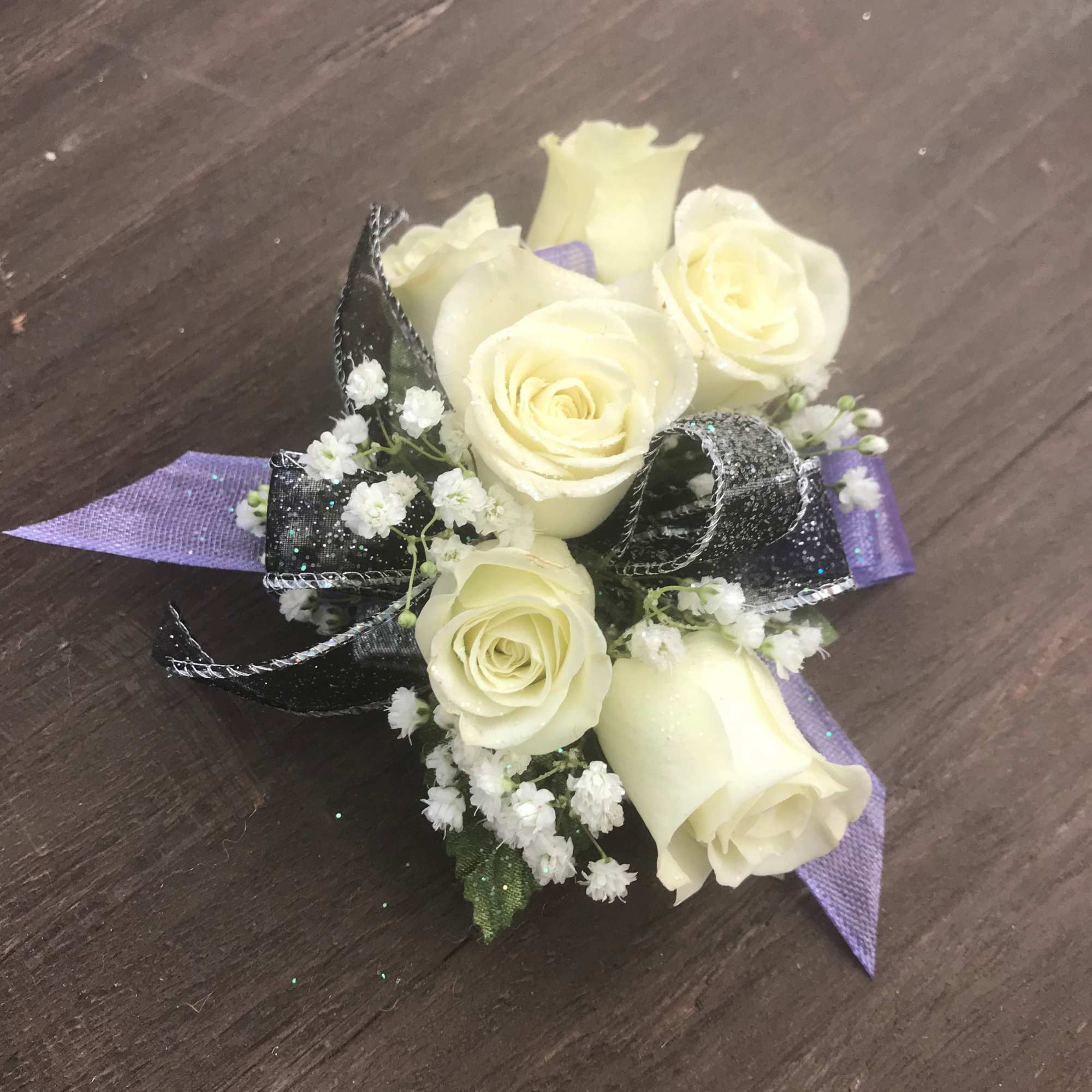 Spray Roses of your color choice with two ribbon accents of your