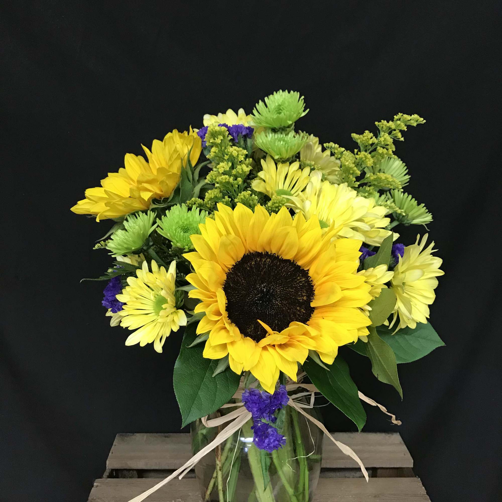 Sunflower and chrysanthemum bouquet in a glass vase