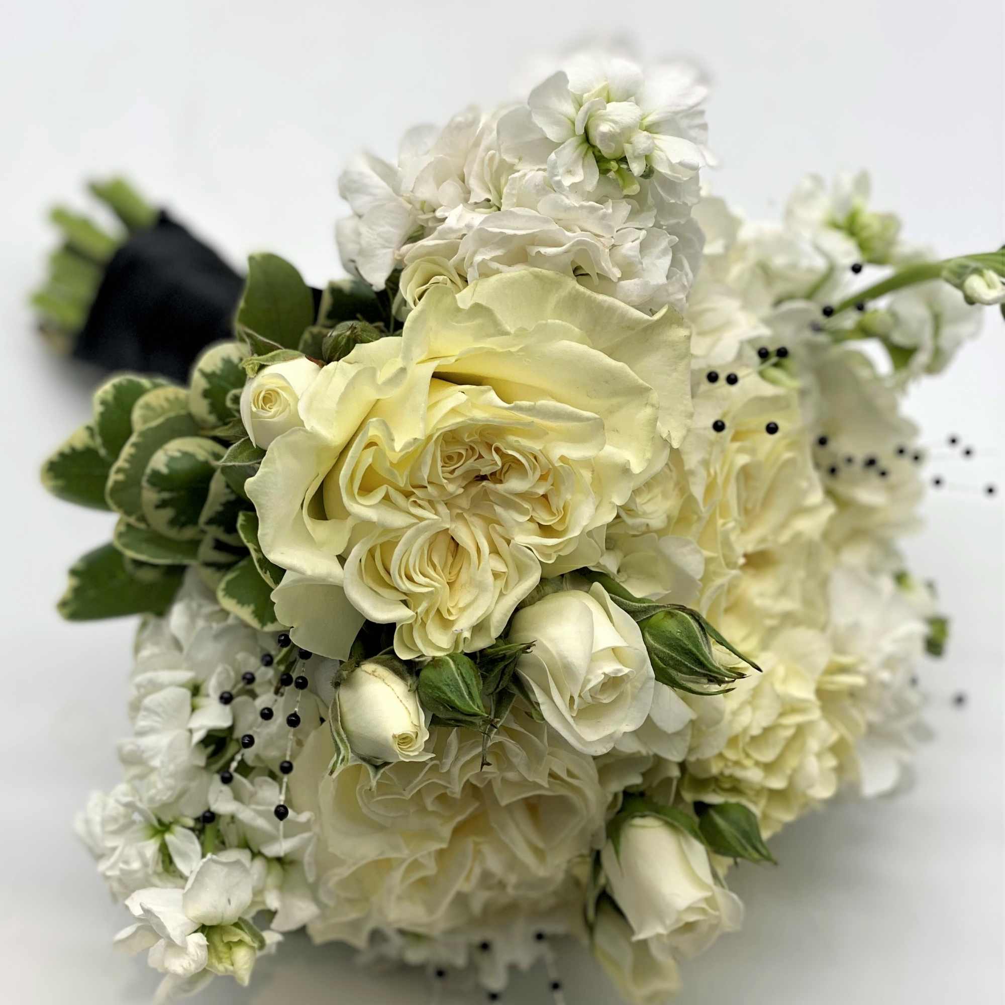 A lush mix of white flowers accented with black pearl sprays with, photo 3 of 3
