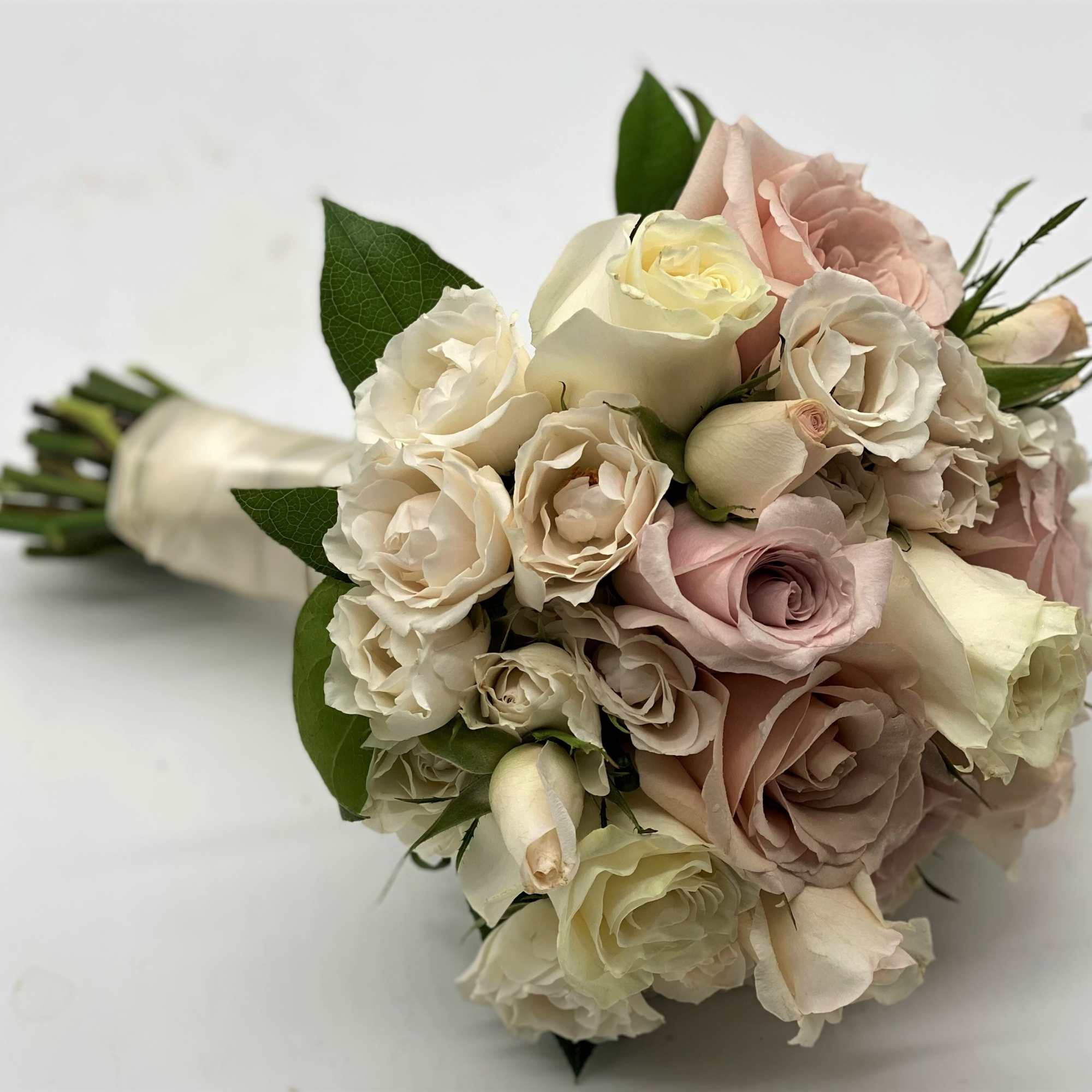 A mix of dusty pinks, creams and lavenders gives this bouquet a