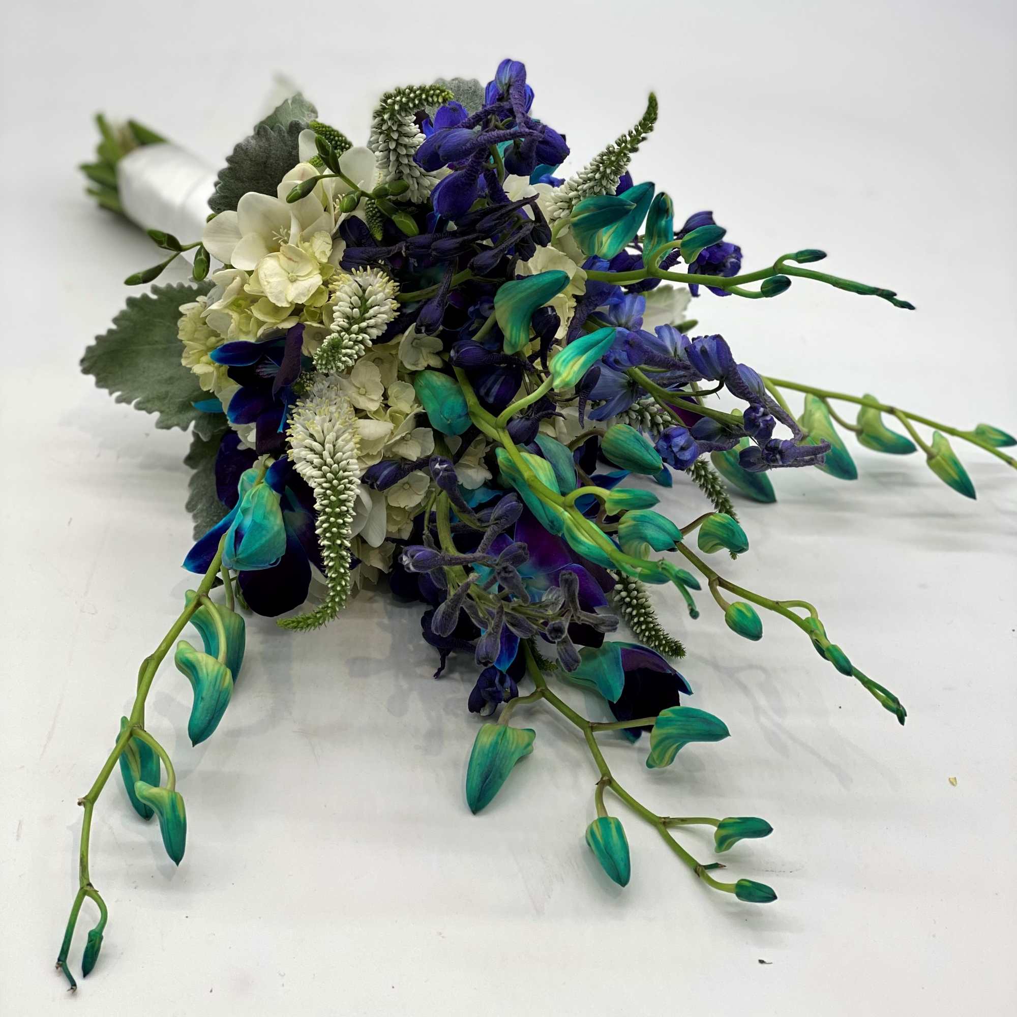 A fun mix of blue orchids, white veronica and blue delphinium sets