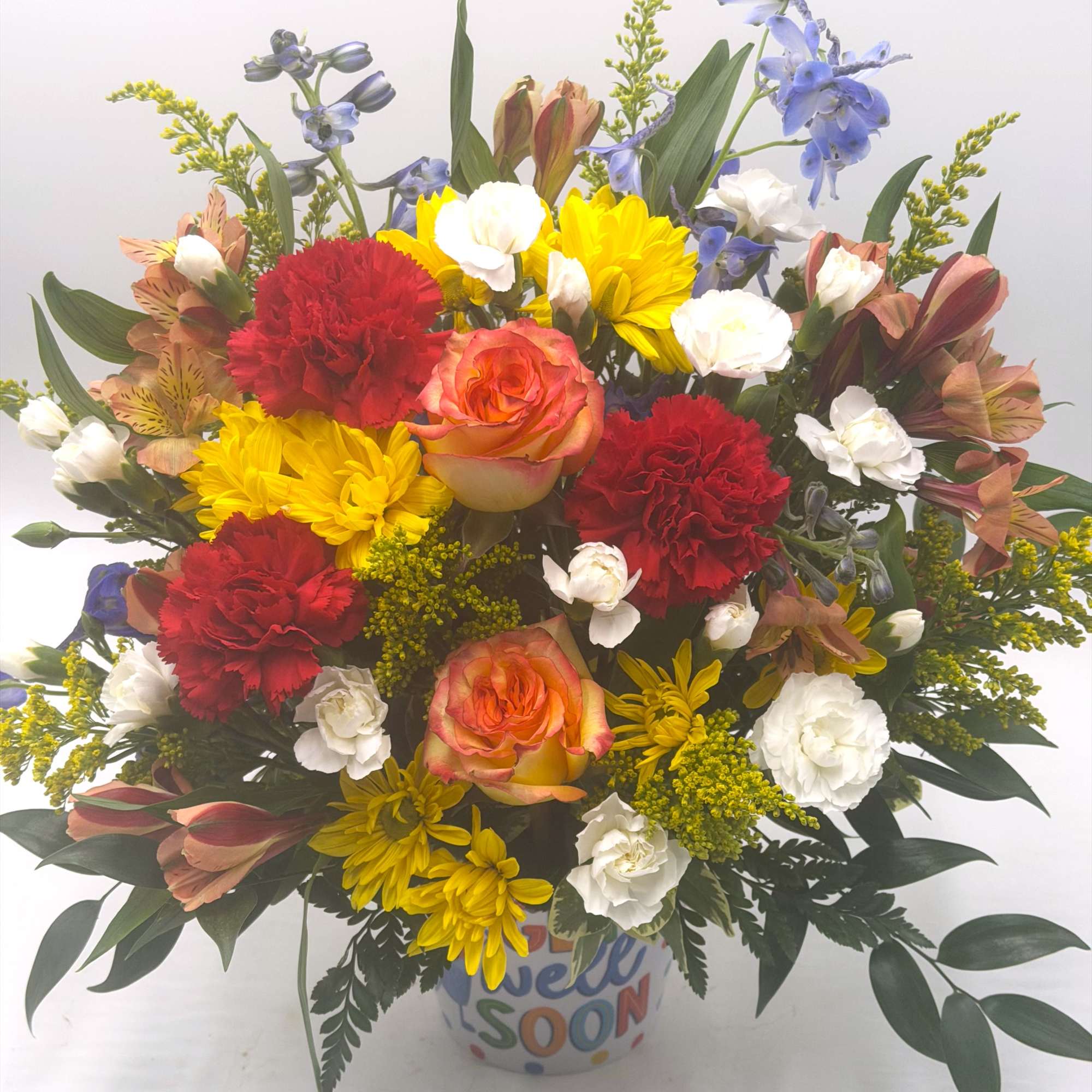 A vibrant get-well arrangement bursting with cheerful yellow daisies, bi-color roses, red