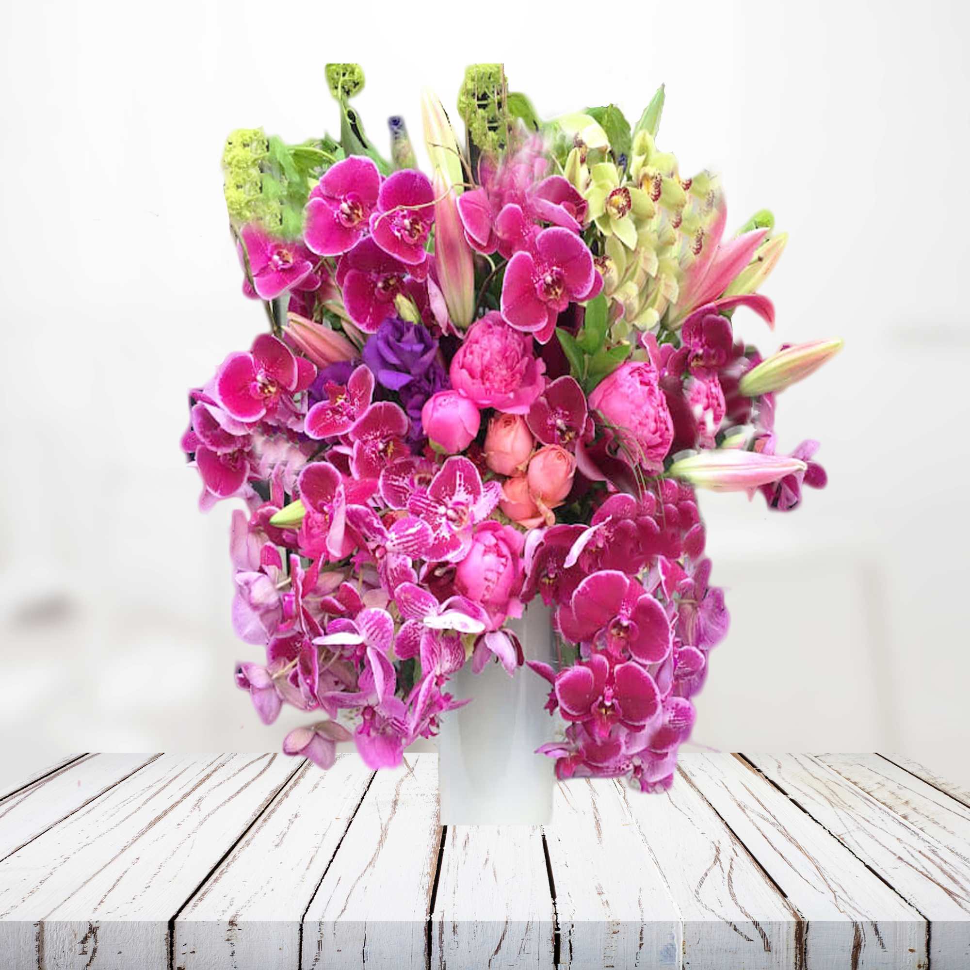 Pink orchid arrangement in a white vase